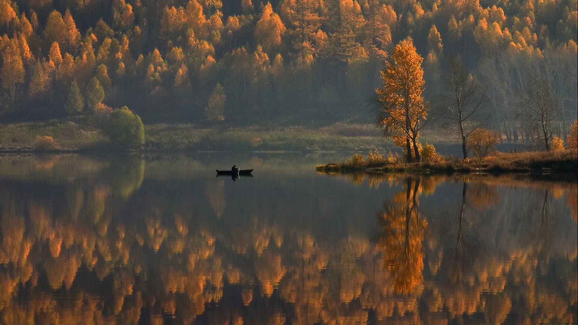 Person in a boat on a lake with autumn trees HD Wallpaper