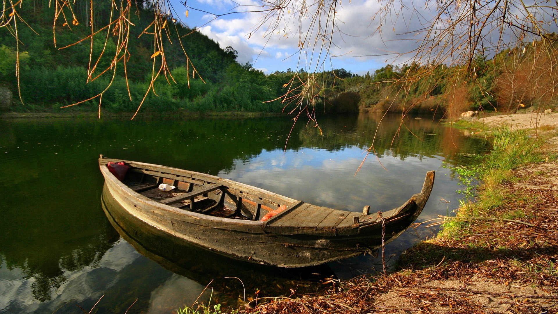Old wooden boat on a calm lake with trees HD Wallpaper