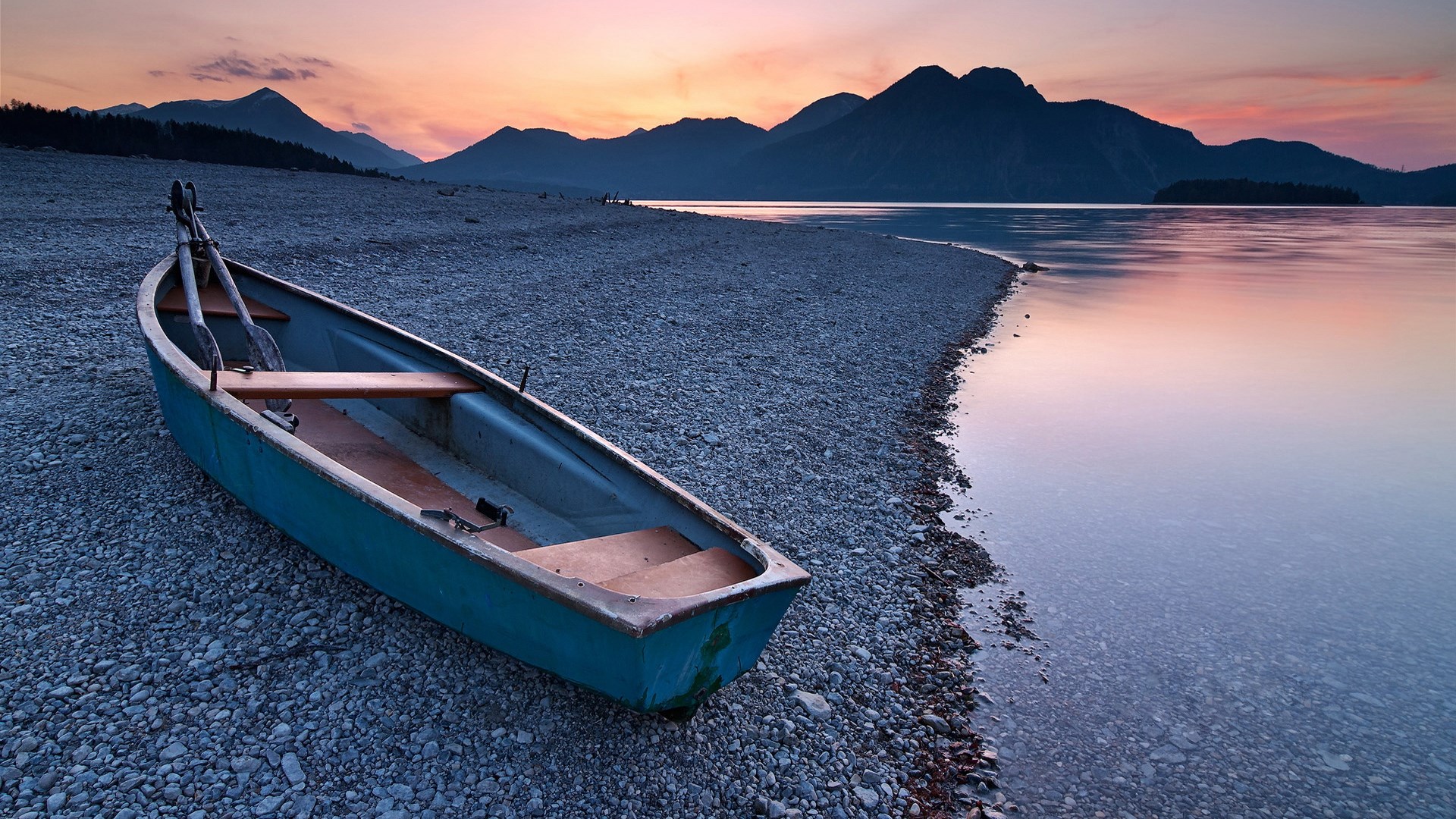 Boat on a rocky shore at sunset HD Wallpaper
