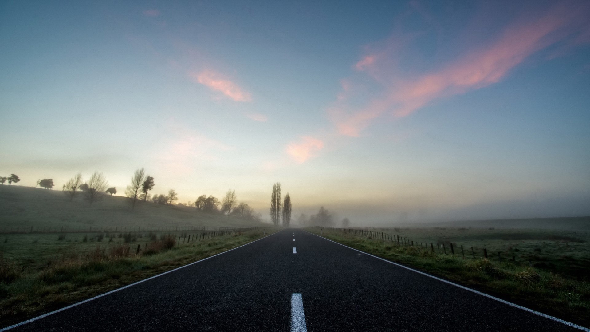 Empty road at sunrise with fog and pink clouds HD Wallpaper