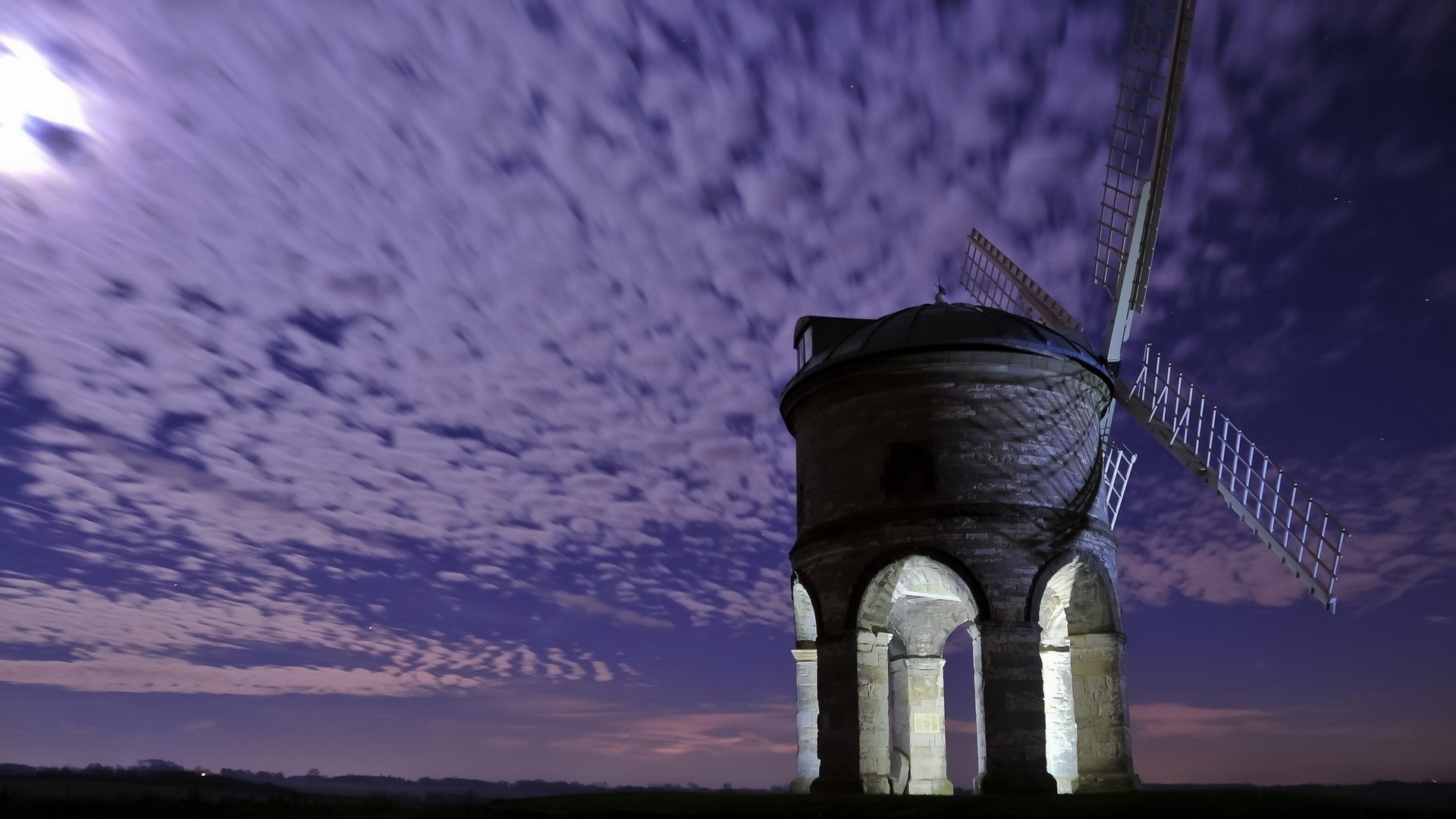 Old stone windmill at night with cloudy sky HD Wallpaper