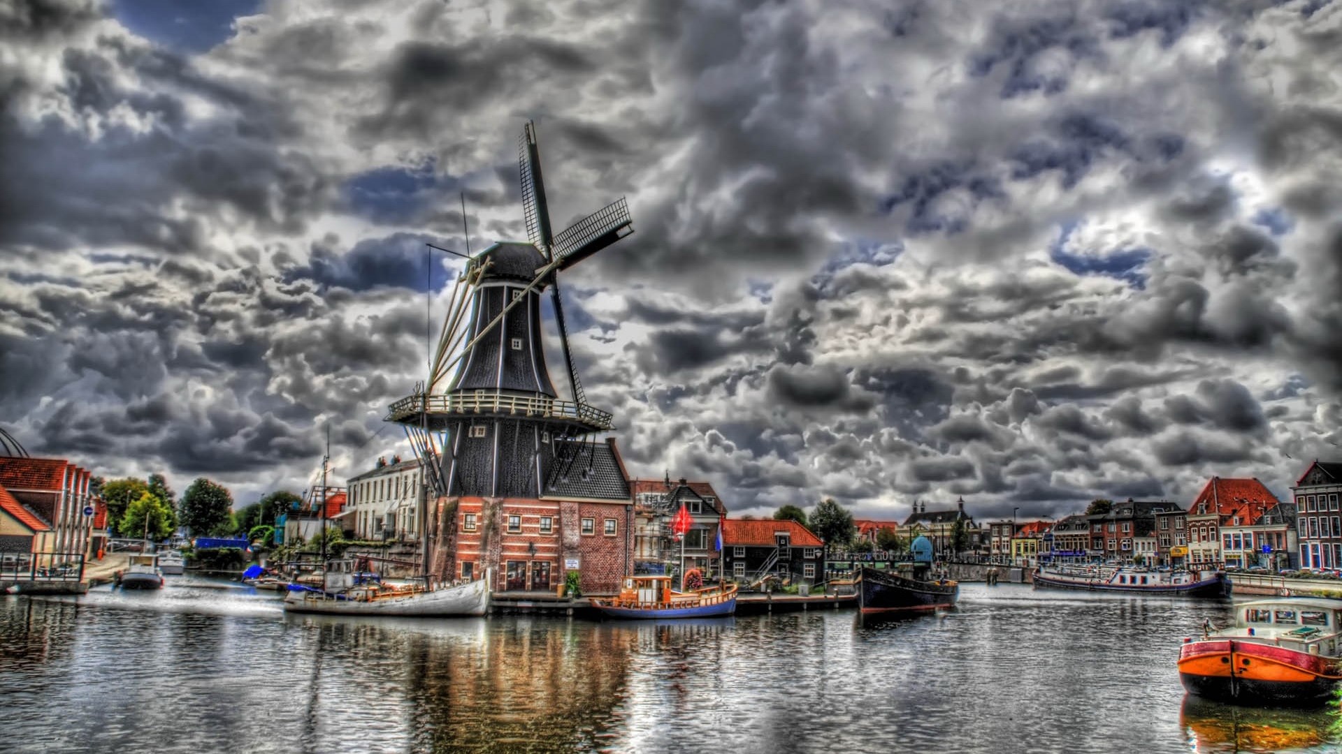 Windmill and boats on a canal under a cloudy sky HD Wallpaper