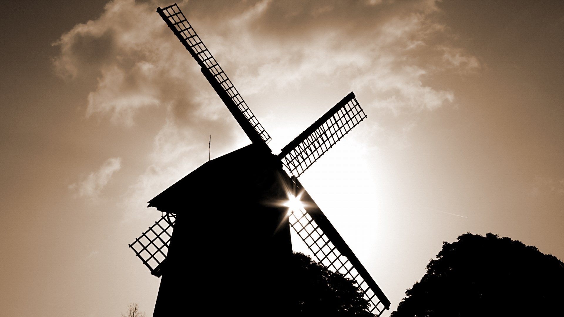 Silhouette of a windmill against the sun and clouds HD Wallpaper