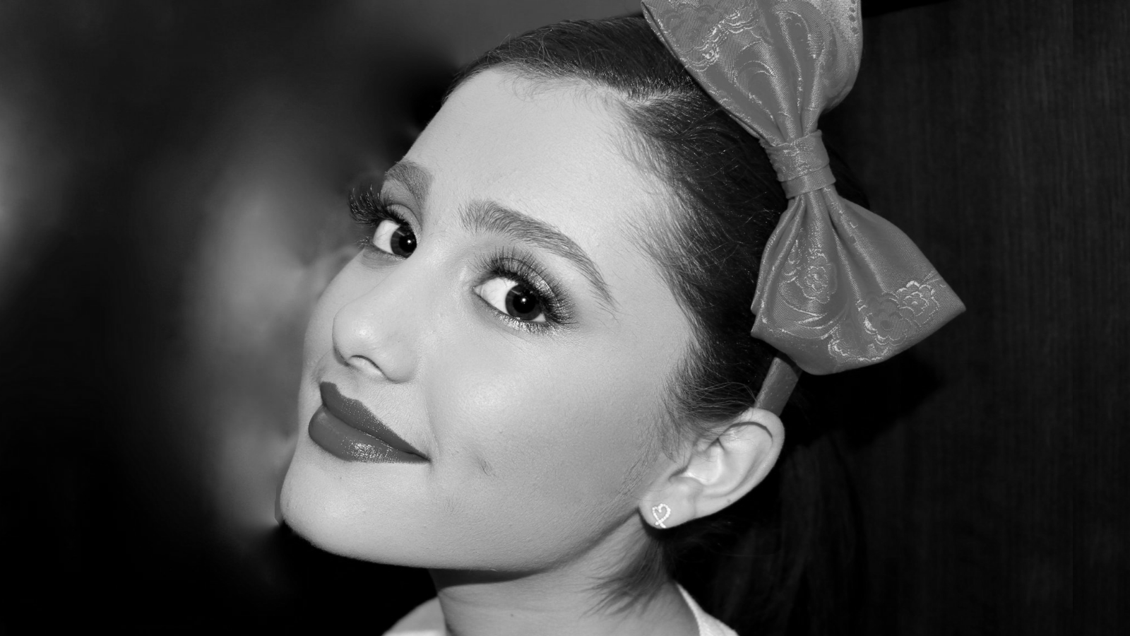 Ariana Grande with a red bow HD Wallpaper