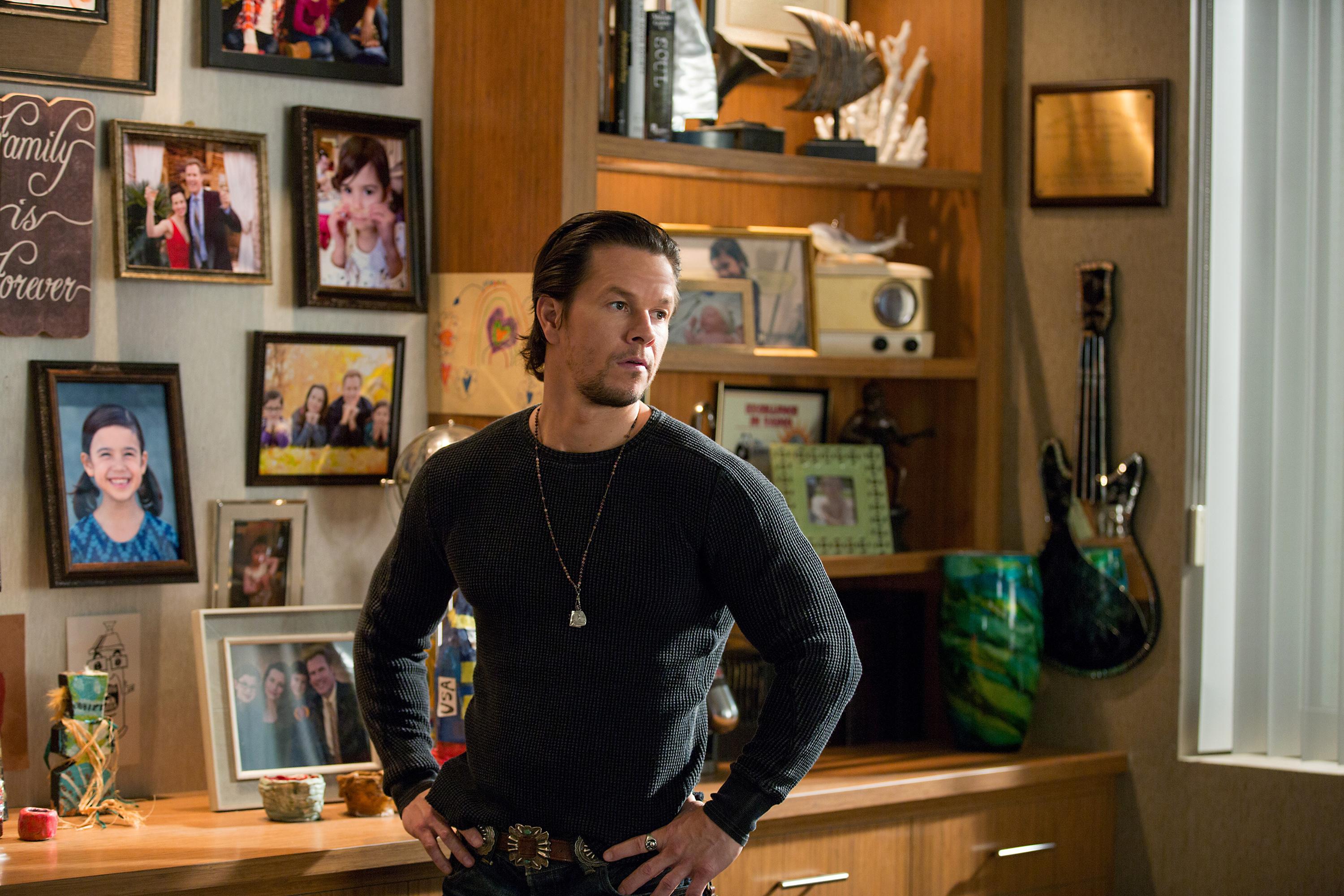 Mark Wahlberg in a room with family photos HD Wallpaper