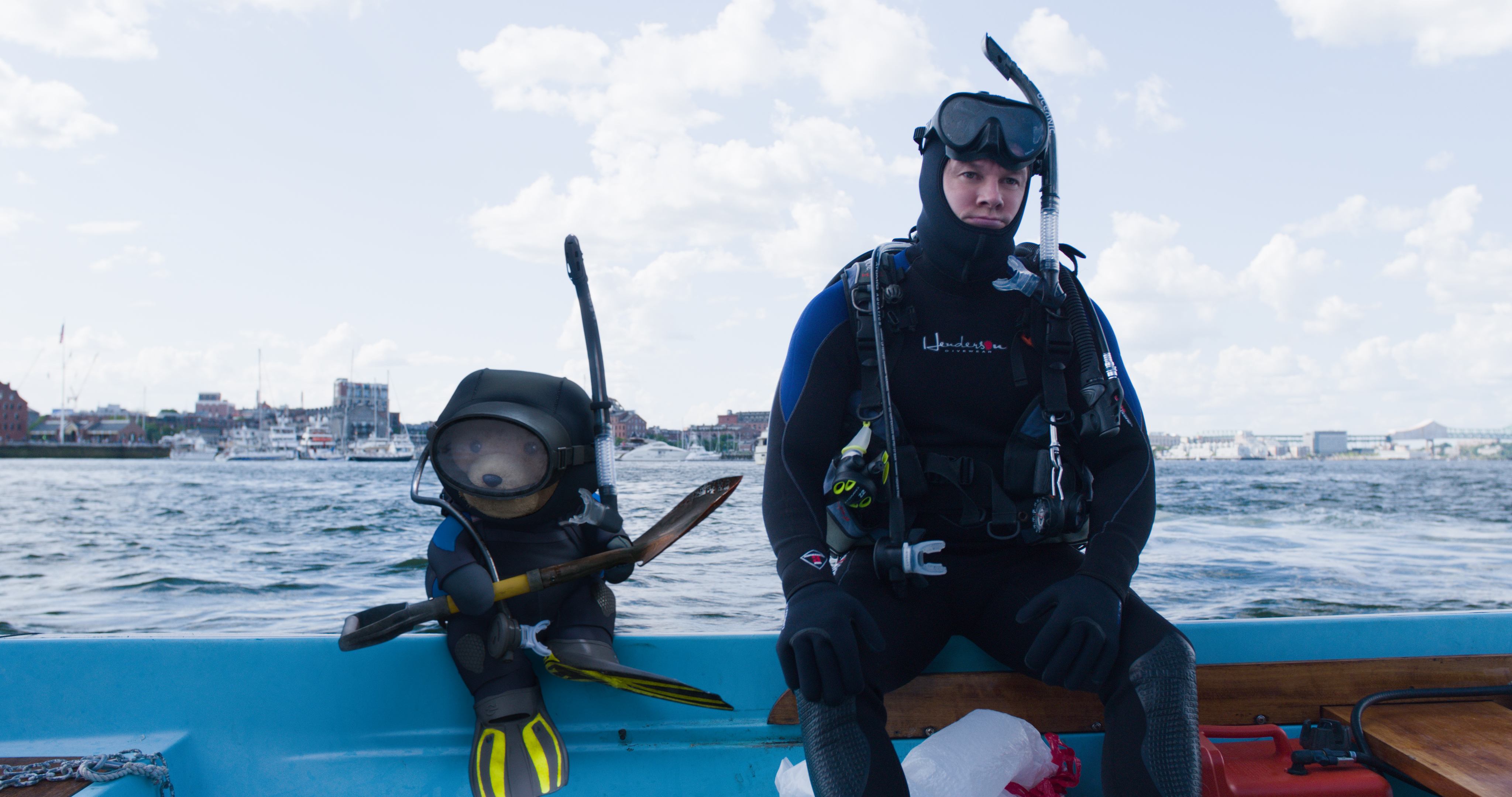 Mark Wahlberg and a teddy bear diver on a boat HD Wallpaper