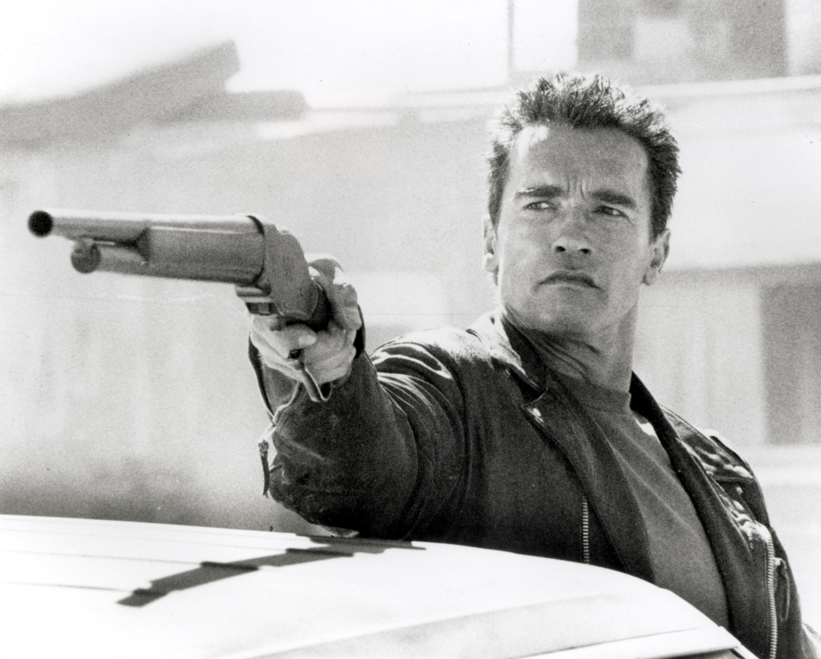 Arnold Schwarzenegger holding a shotgun HD Wallpaper