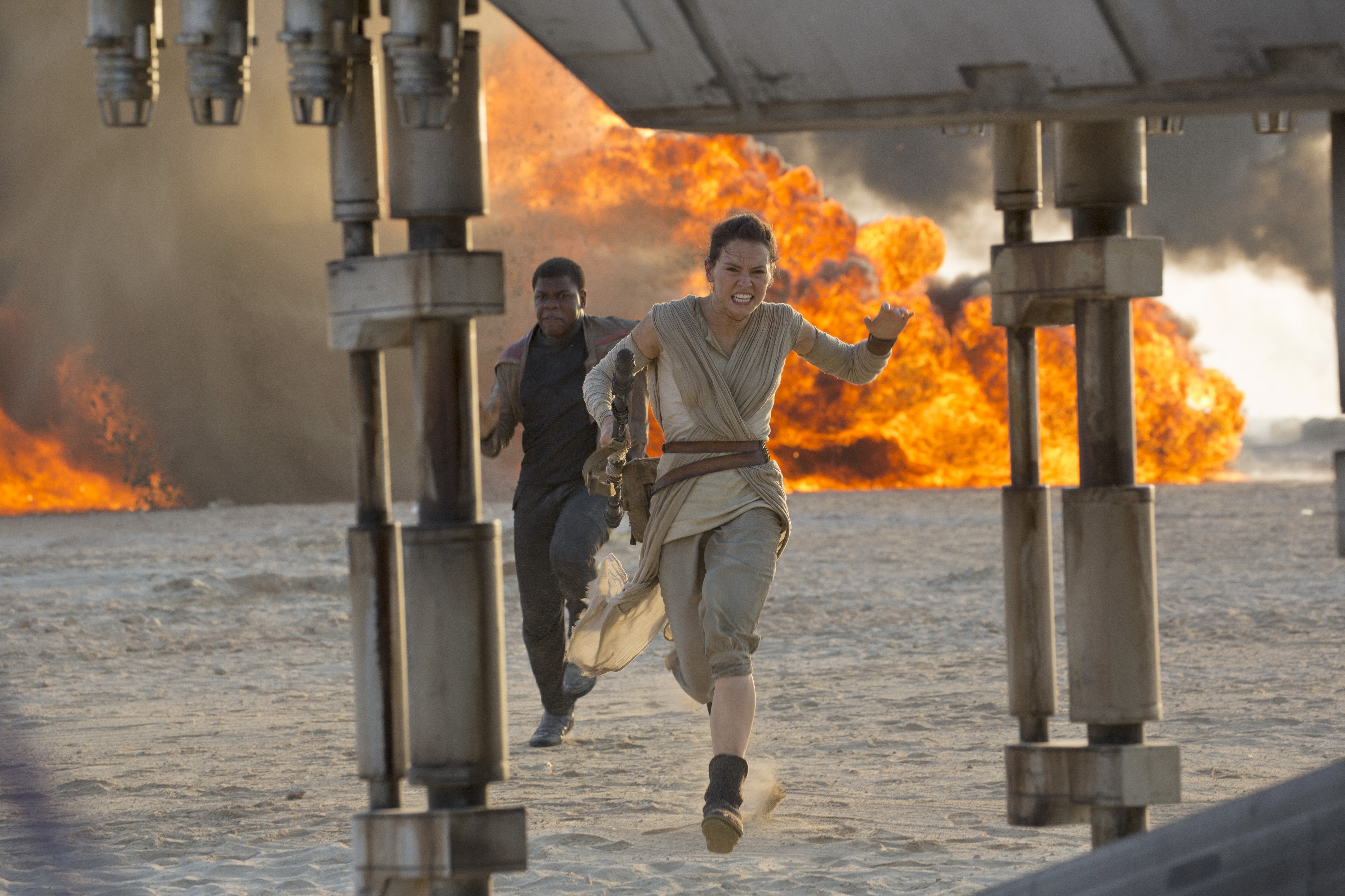 Rey and Finn from Star Wars running from an explosion HD Wallpaper
