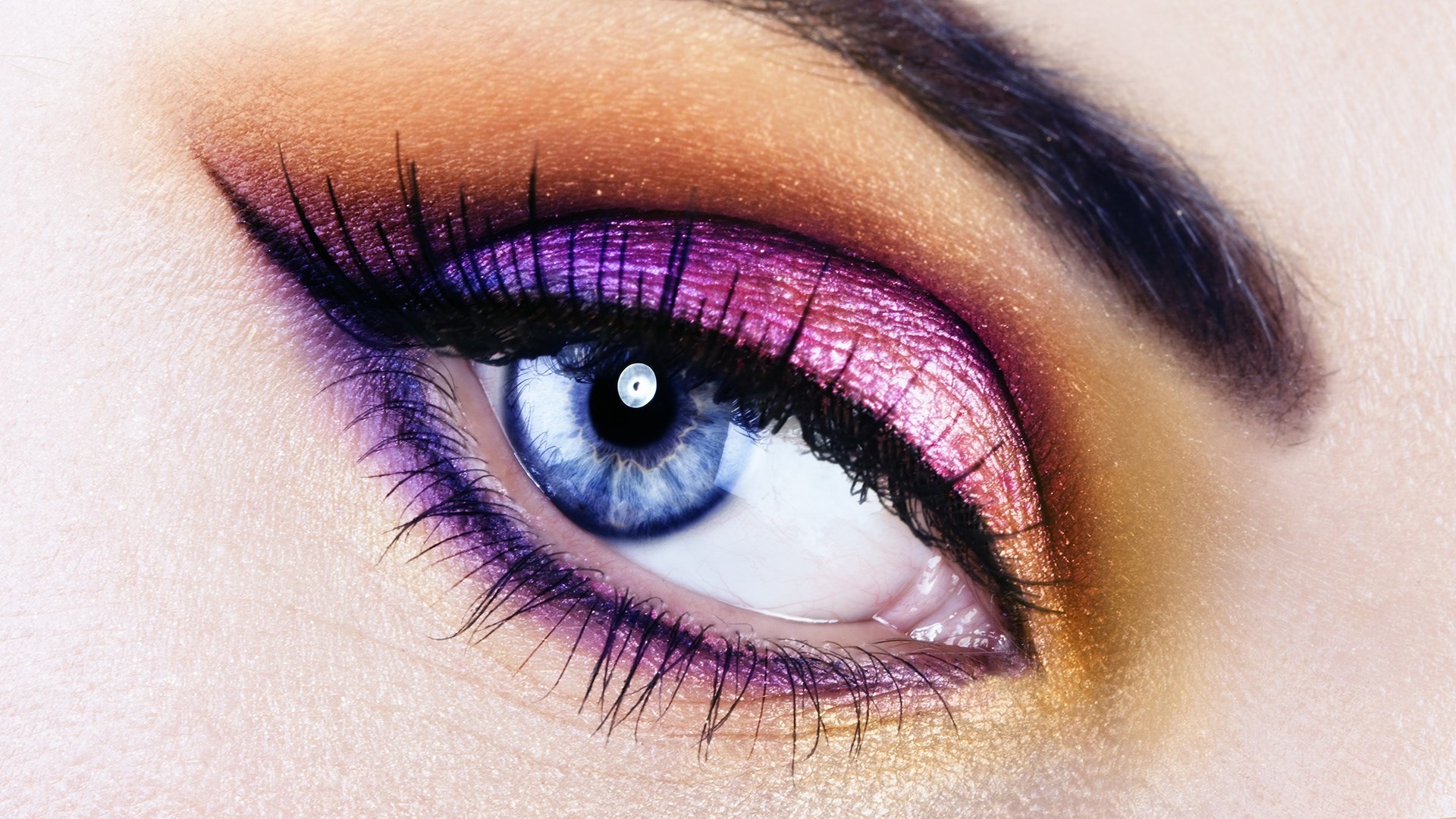 Close-up of a woman's eye with dramatic makeup HD Wallpaper