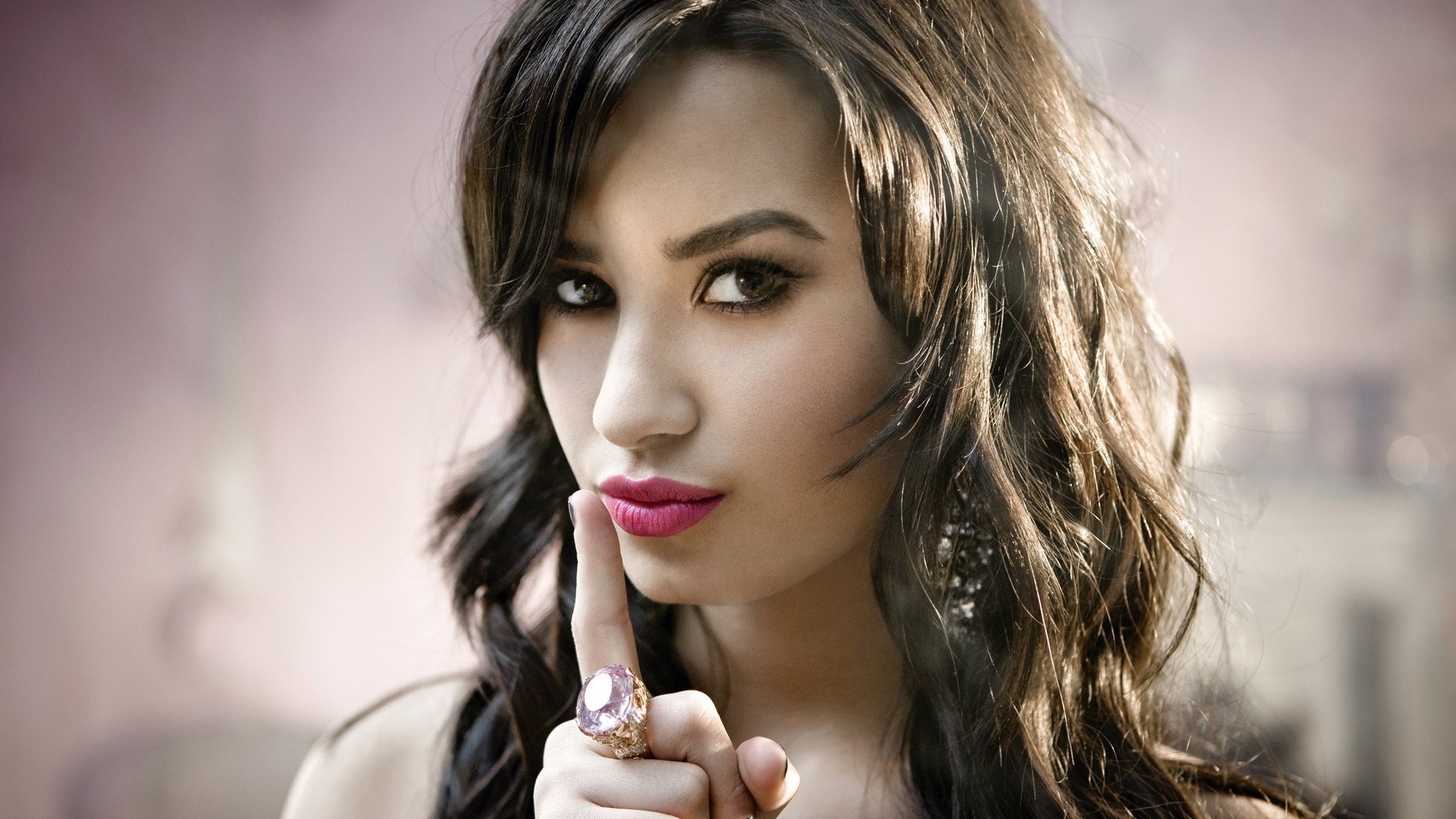 Woman with finger to lips and large ring HD Wallpaper