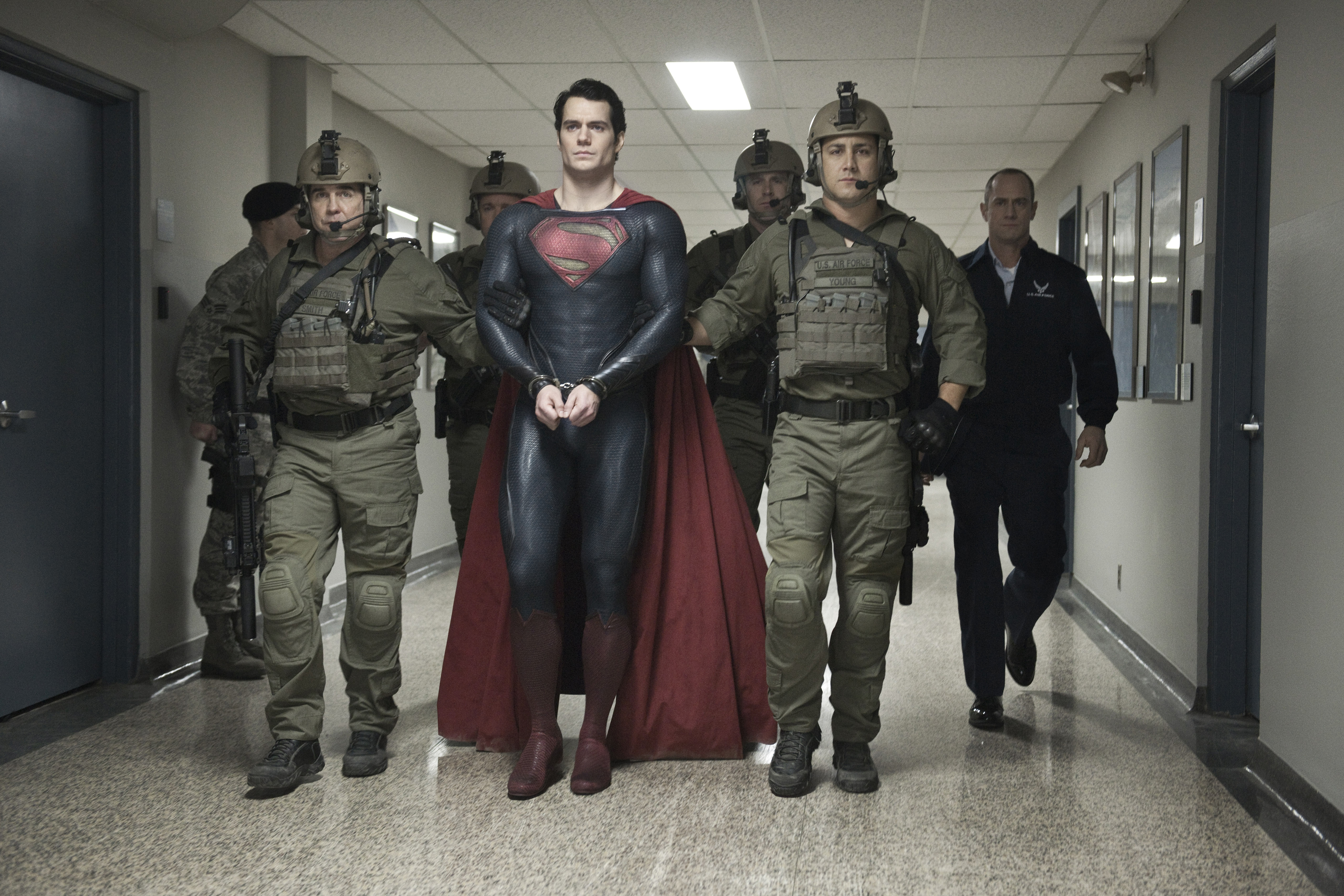 Superman from DC Comics in handcuffs with military escort HD Wallpaper
