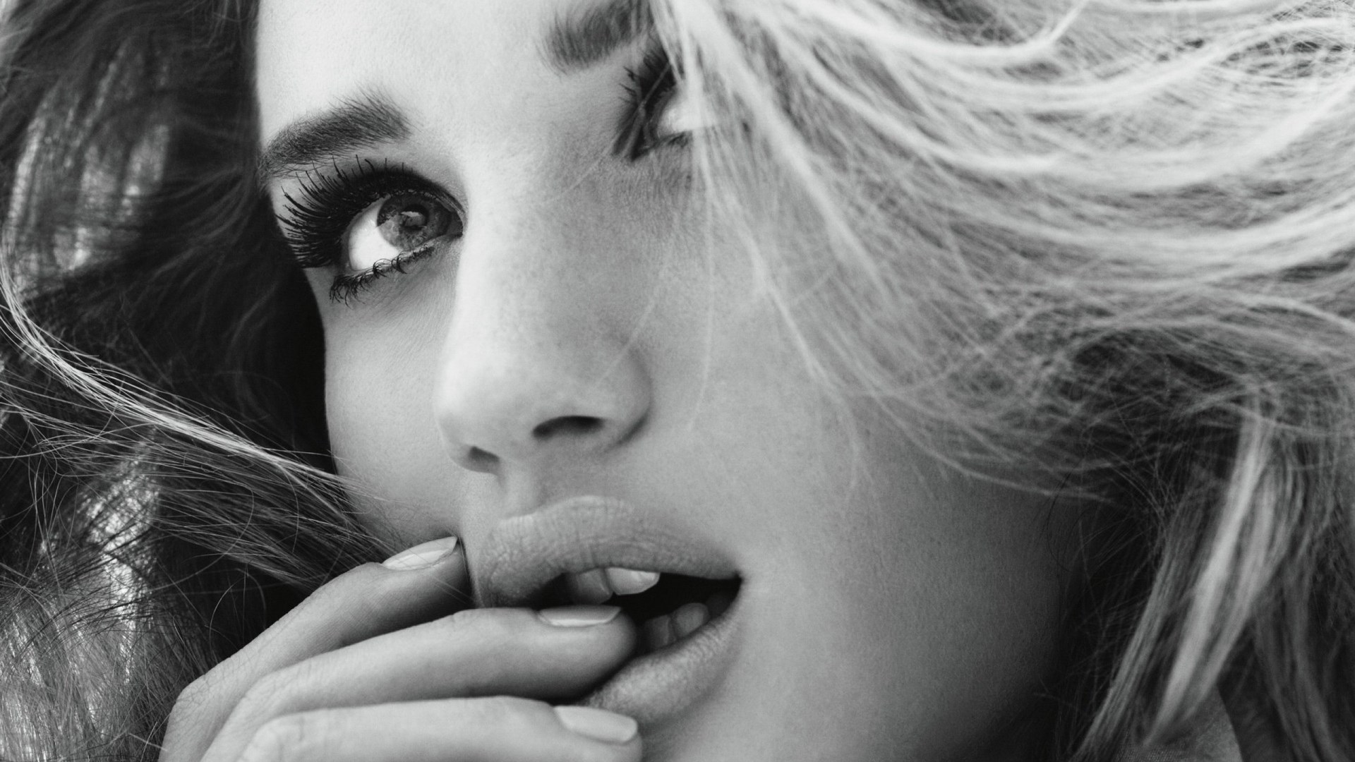 Close-up of a woman biting her finger HD Wallpaper