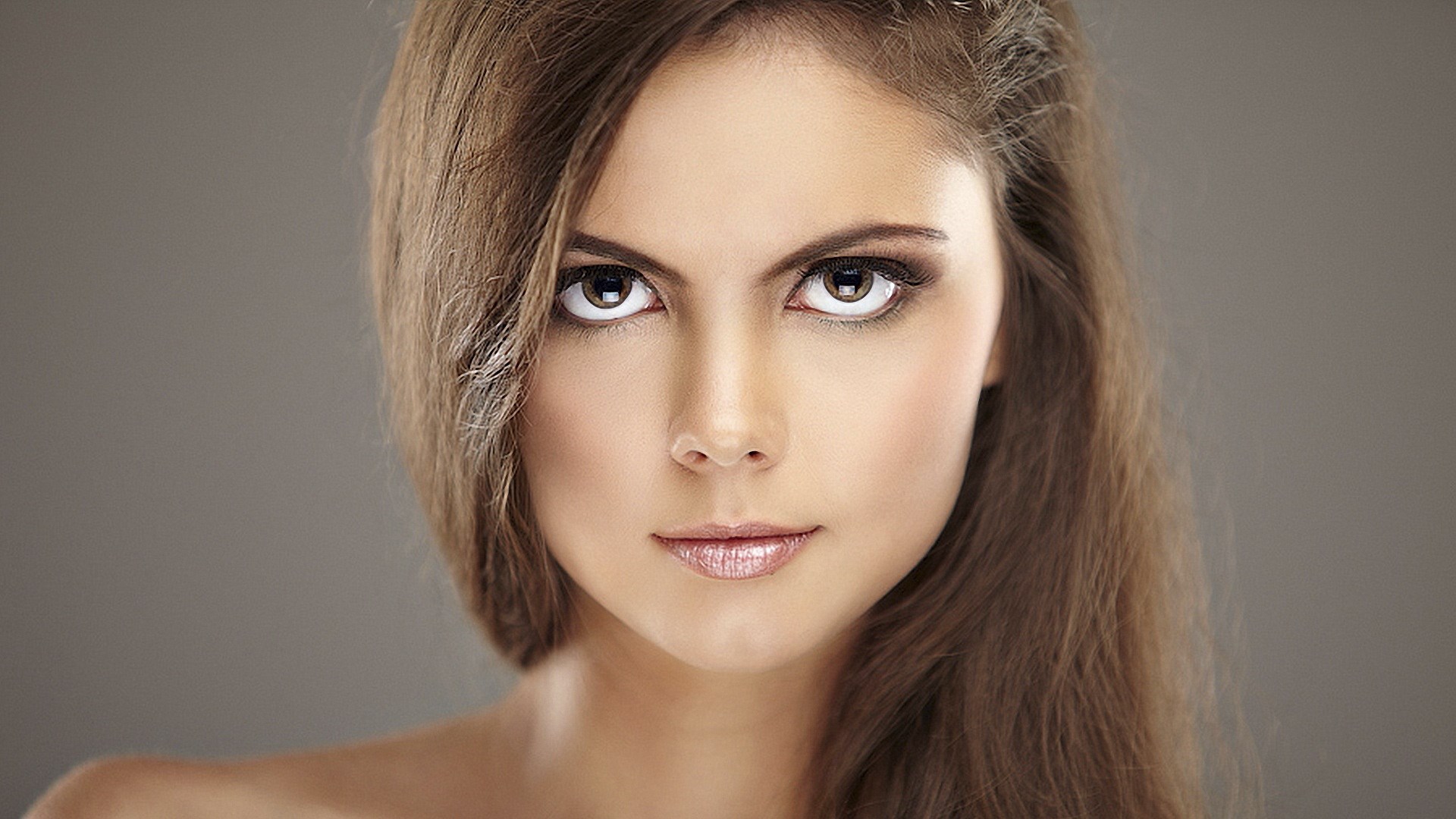 Woman with long brown hair and makeup HD Wallpaper