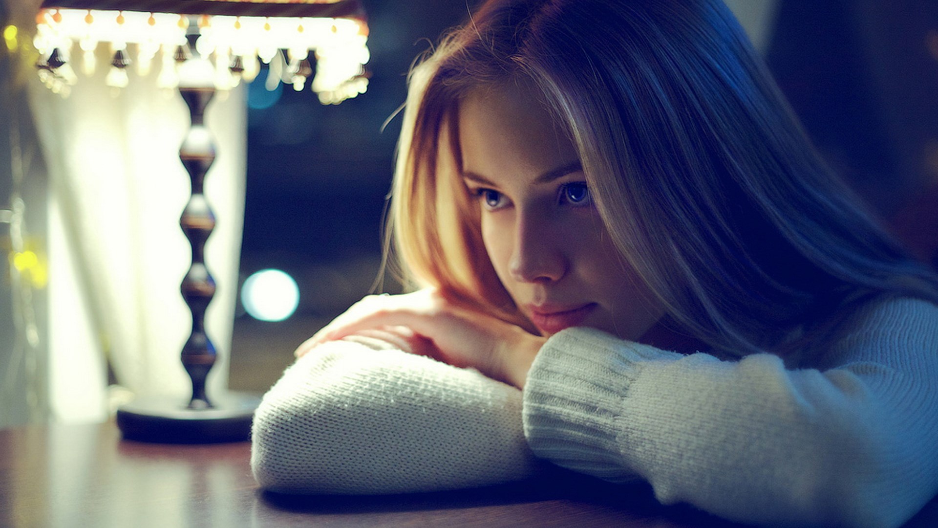 Young woman resting her head on her arms HD Wallpaper