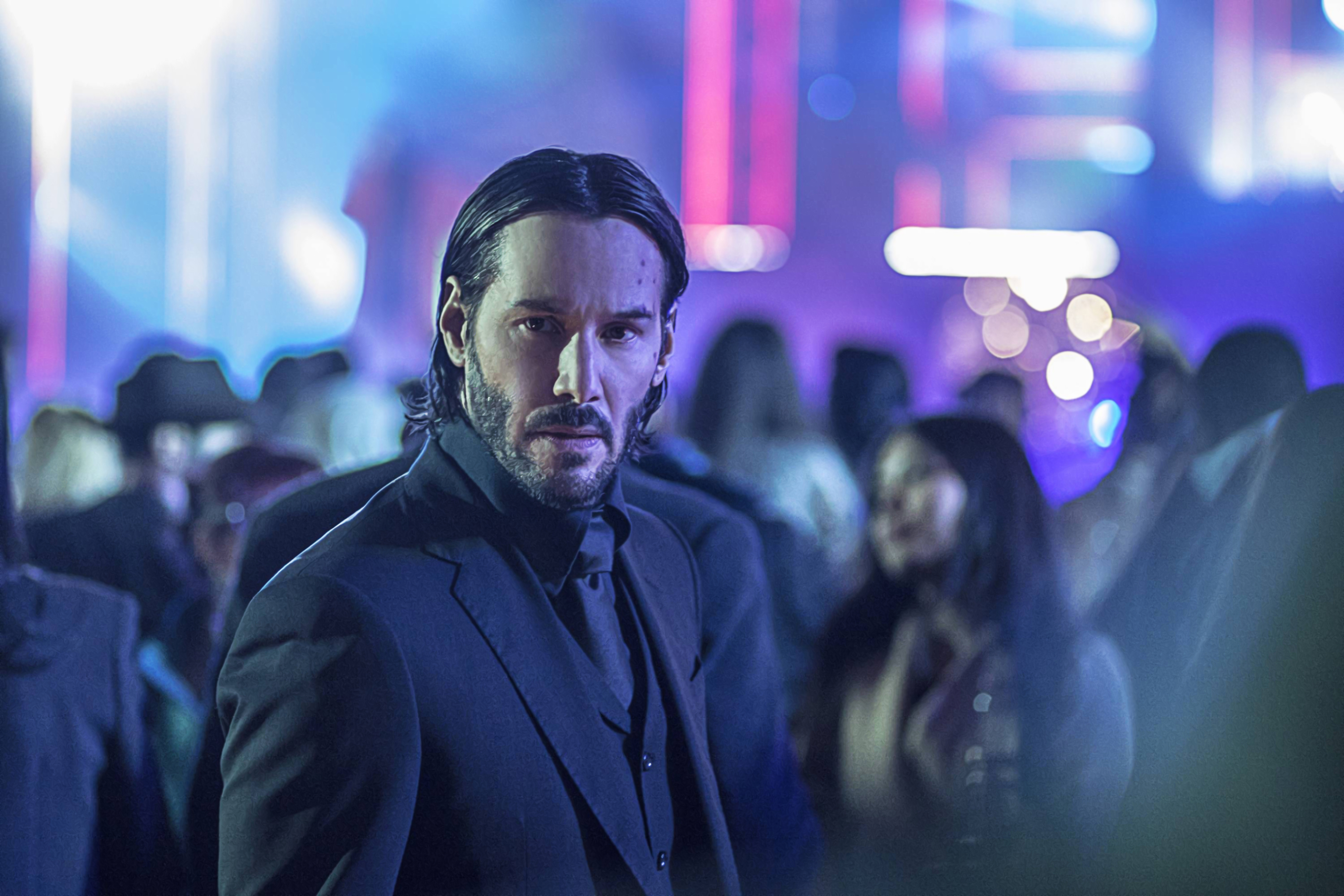 Keanu Reeves in a dark suit at a club HD Wallpaper