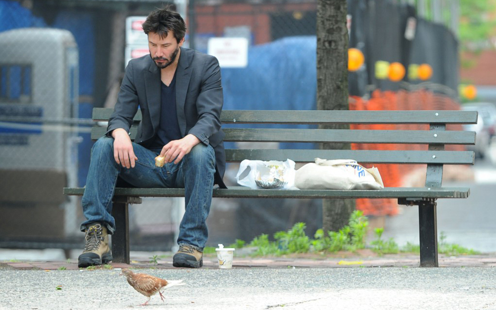 Keanu Reeves sitting on a park bench HD Wallpaper