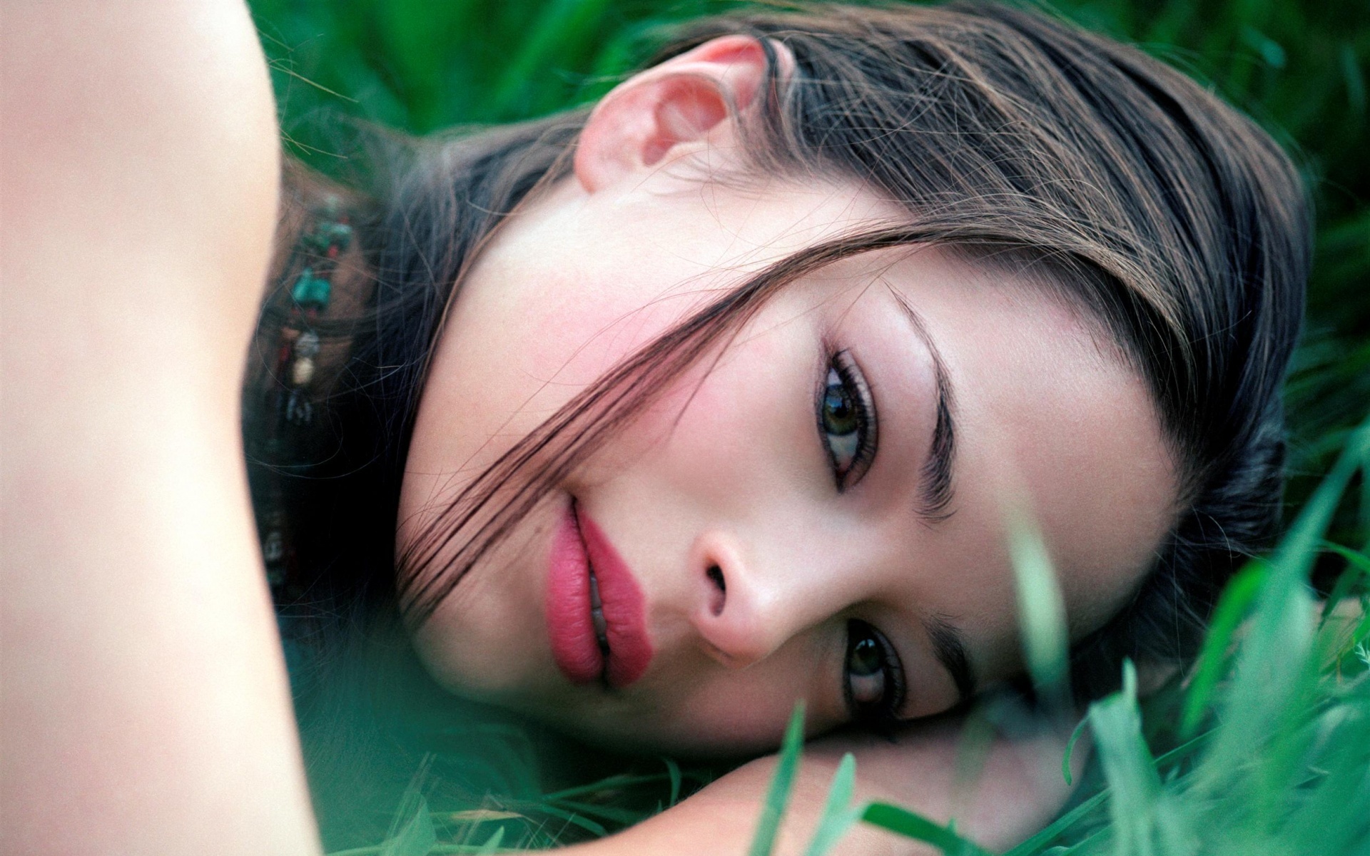 Kristin Kreuk lying in grass HD Wallpaper