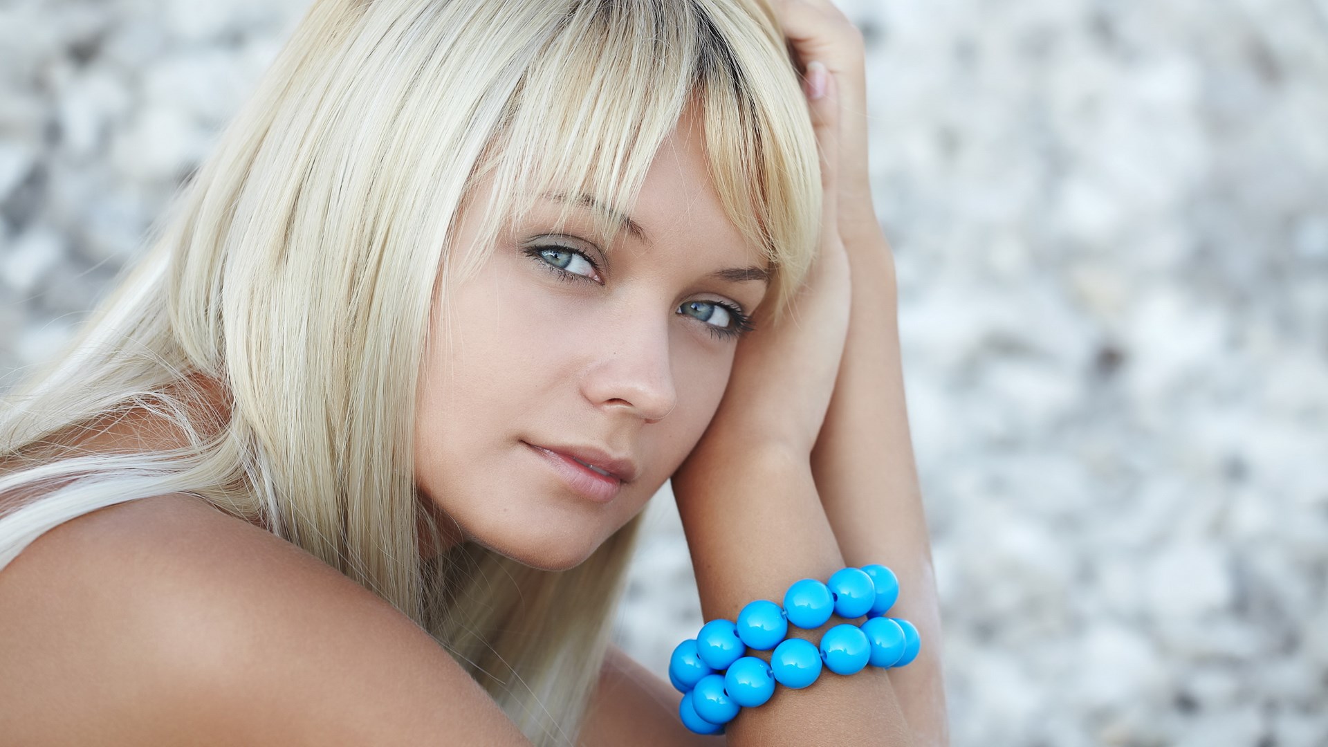 Young woman with blonde hair and blue bracelet HD Wallpaper