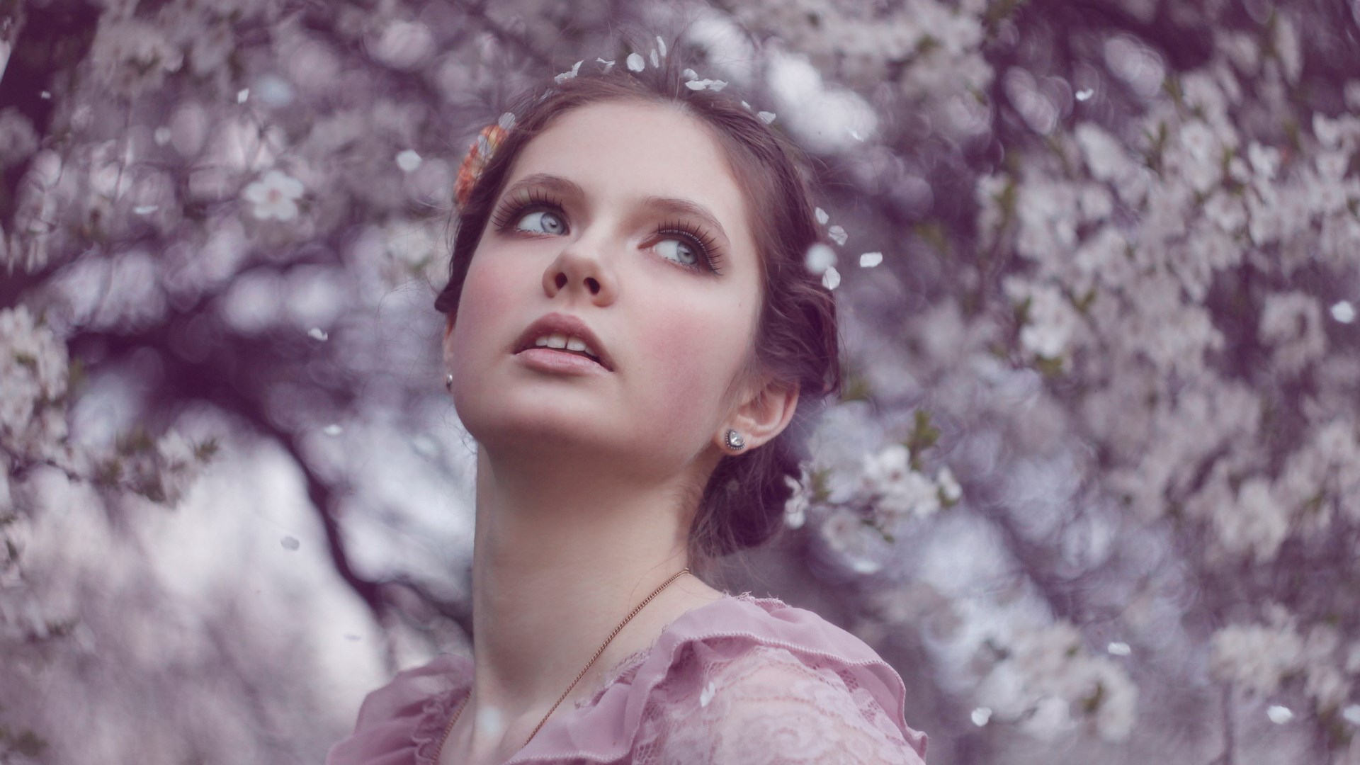 Young woman with flowers in her hair HD Wallpaper