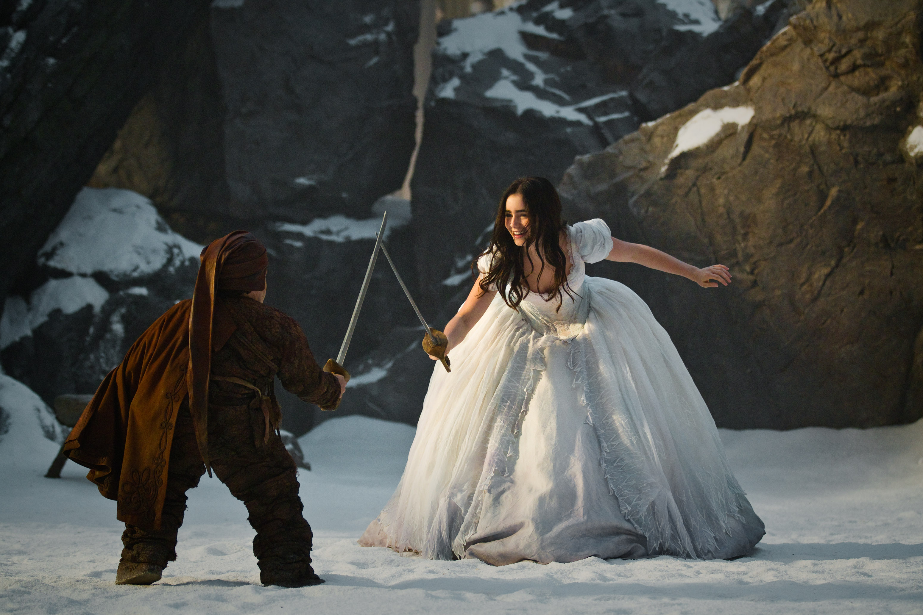 Lily Collins in a white dress fighting with a dwarf HD Wallpaper