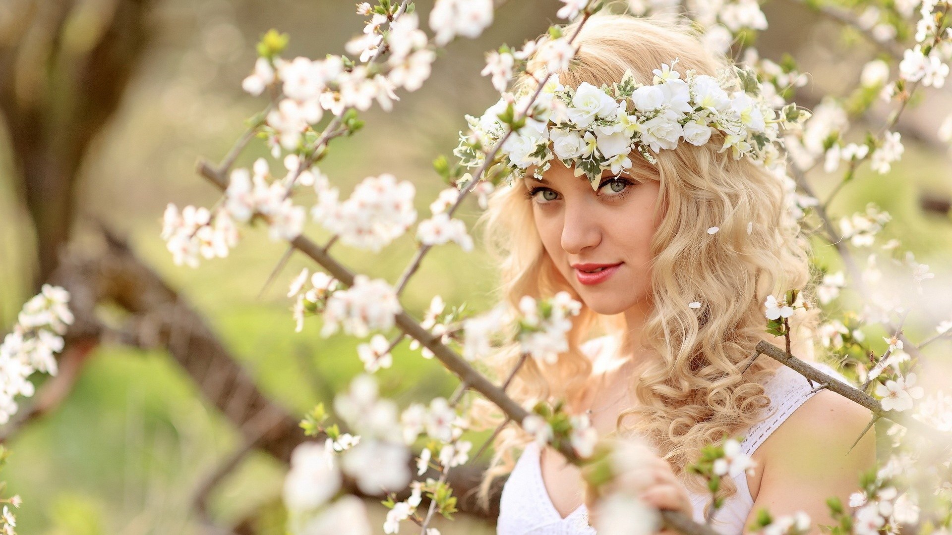 Woman with flower crown in blooming tree HD Wallpaper