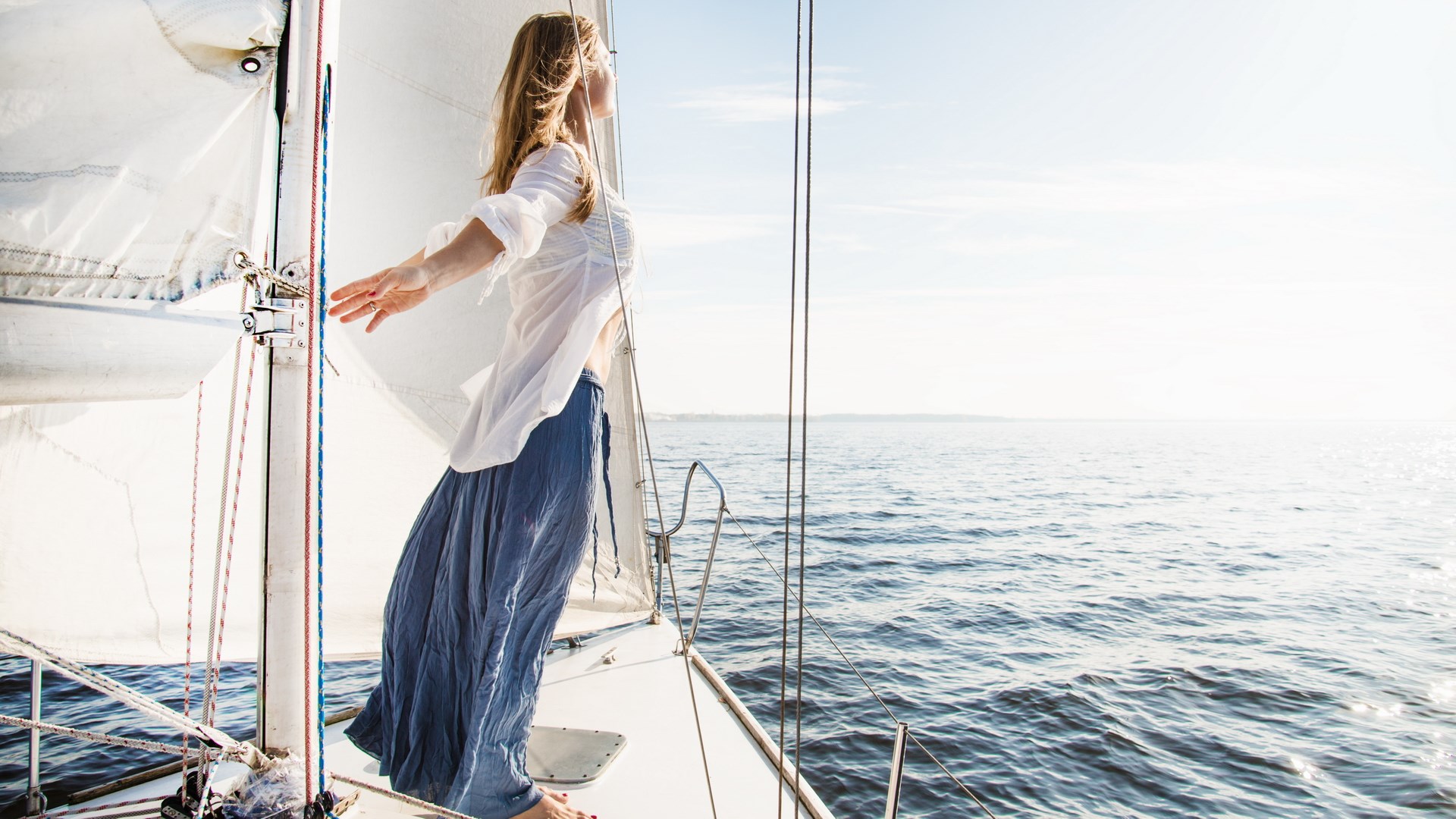 Woman on a sailboat enjoying the ocean view HD Wallpaper