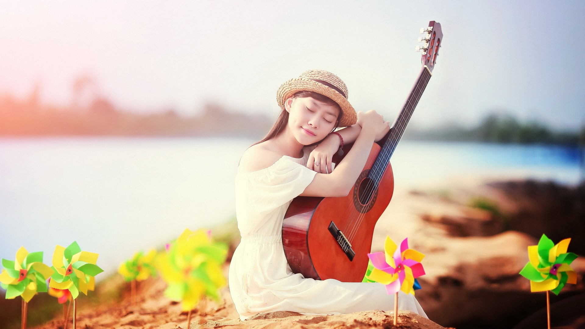 Girl with guitar on beach with pinwheels HD Wallpaper