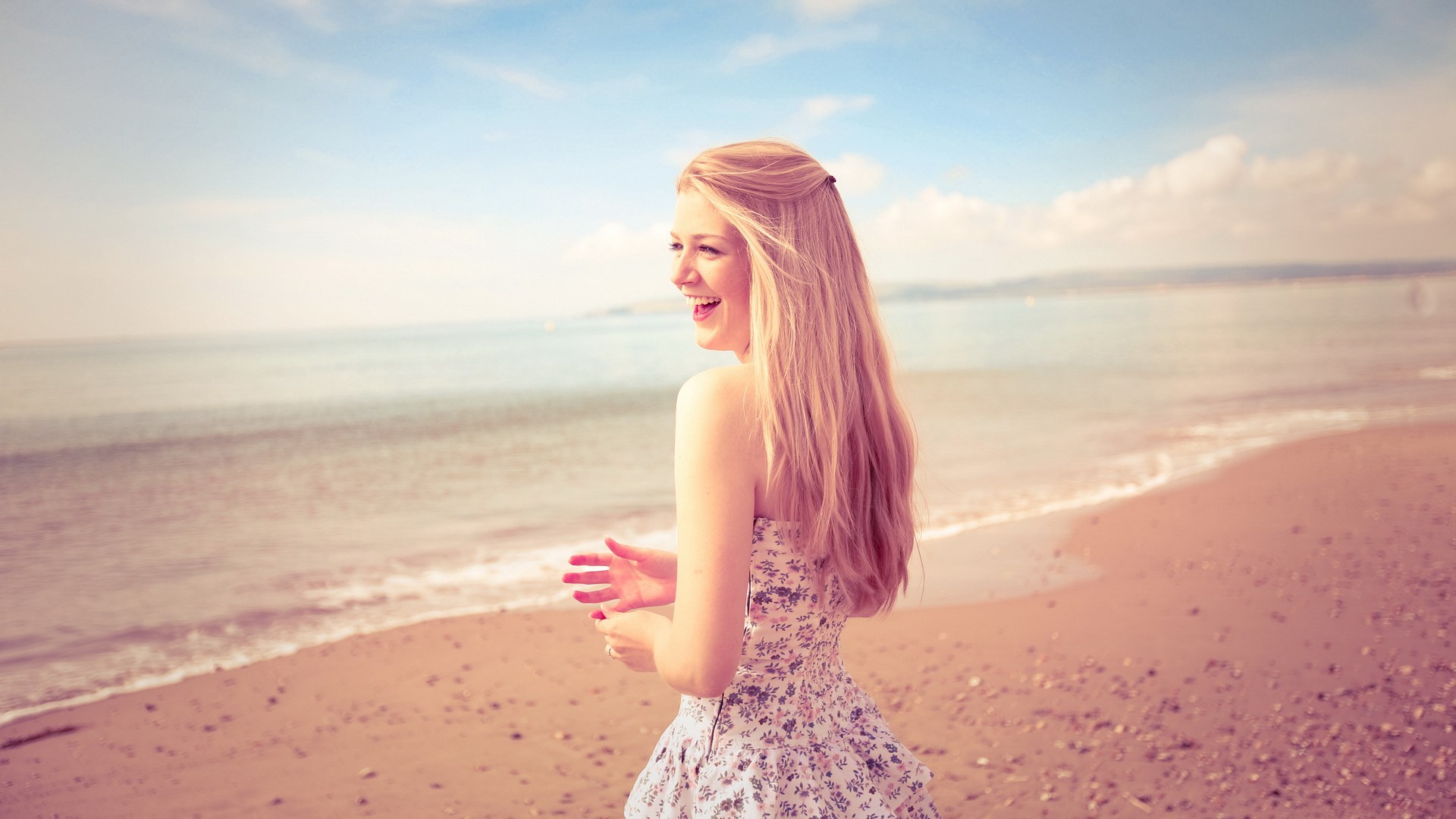 Woman in a floral dress on a beach HD Wallpaper