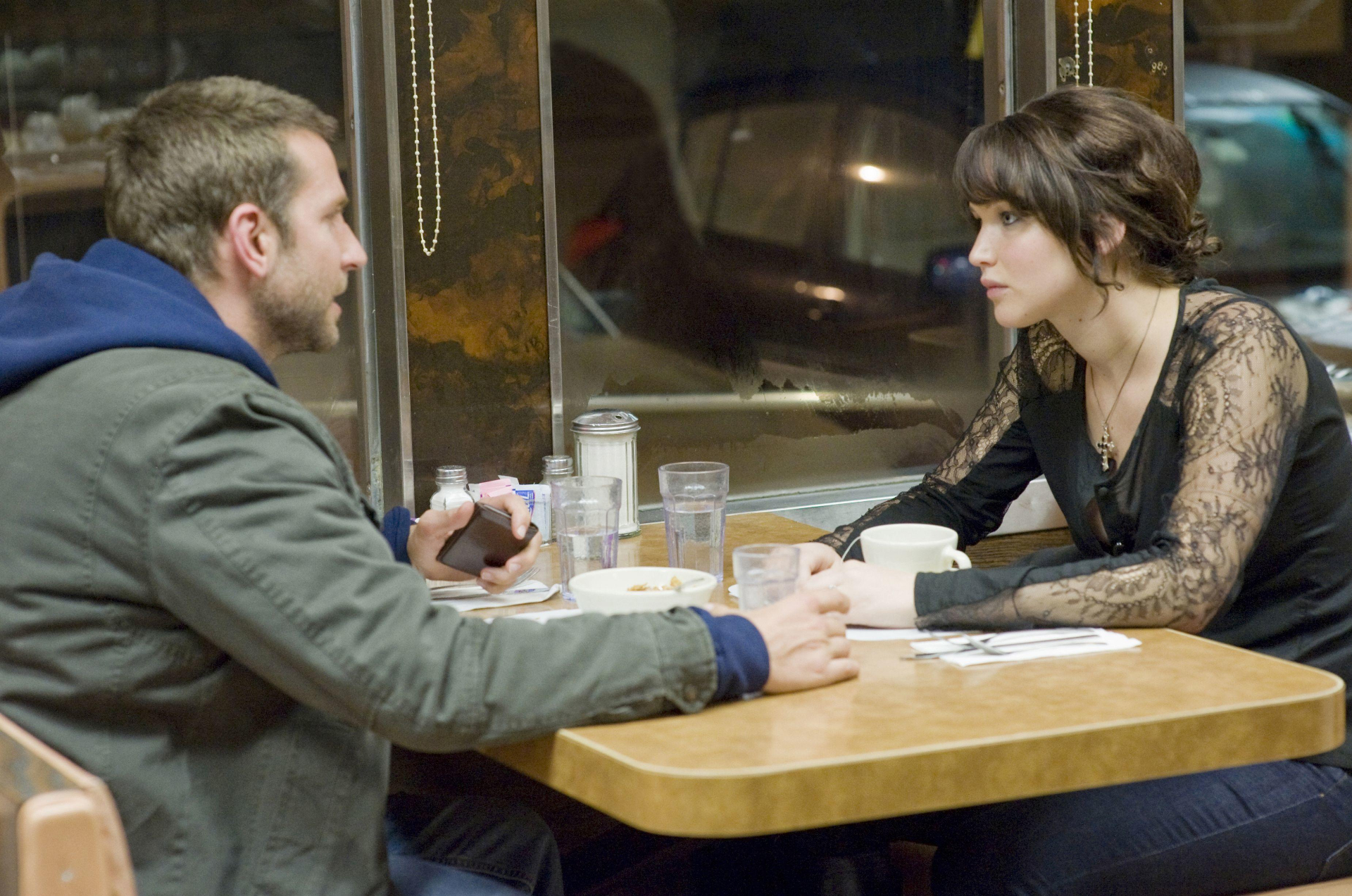 Bradley Cooper and Jennifer Lawrence in a diner HD Wallpaper