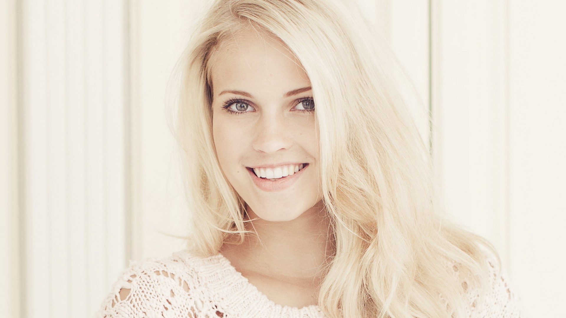 Young woman with blonde hair smiling HD Wallpaper