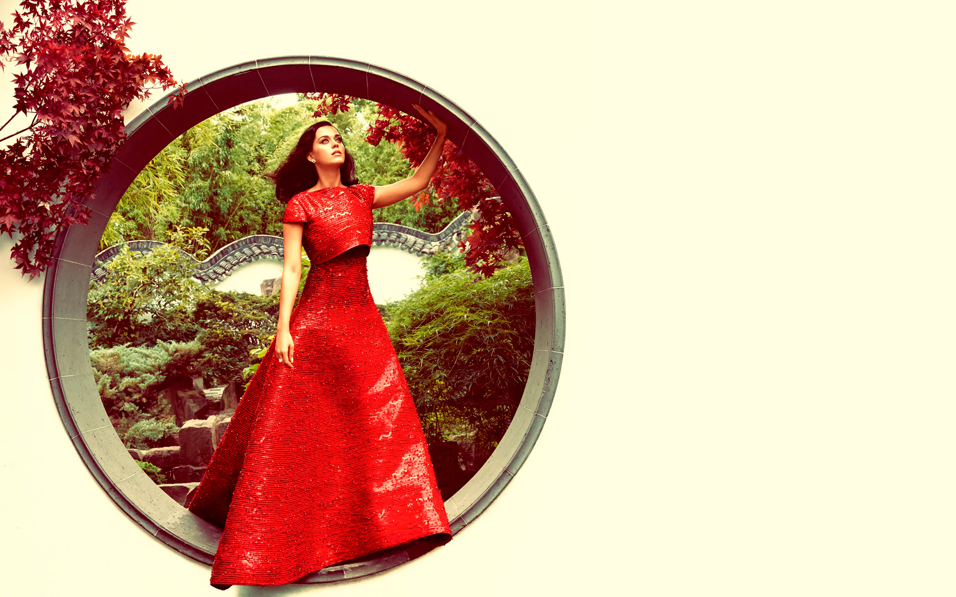Katy Perry in a red dress in a garden HD Wallpaper