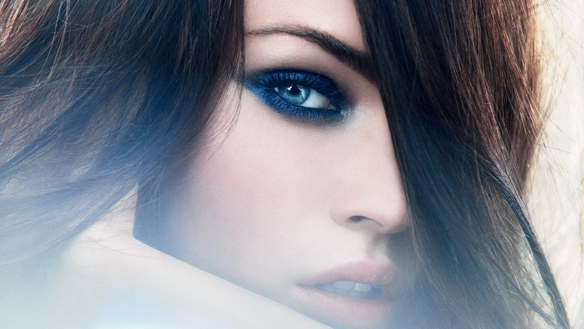 Close-up of a woman's face with blue eyeshadow HD Wallpaper