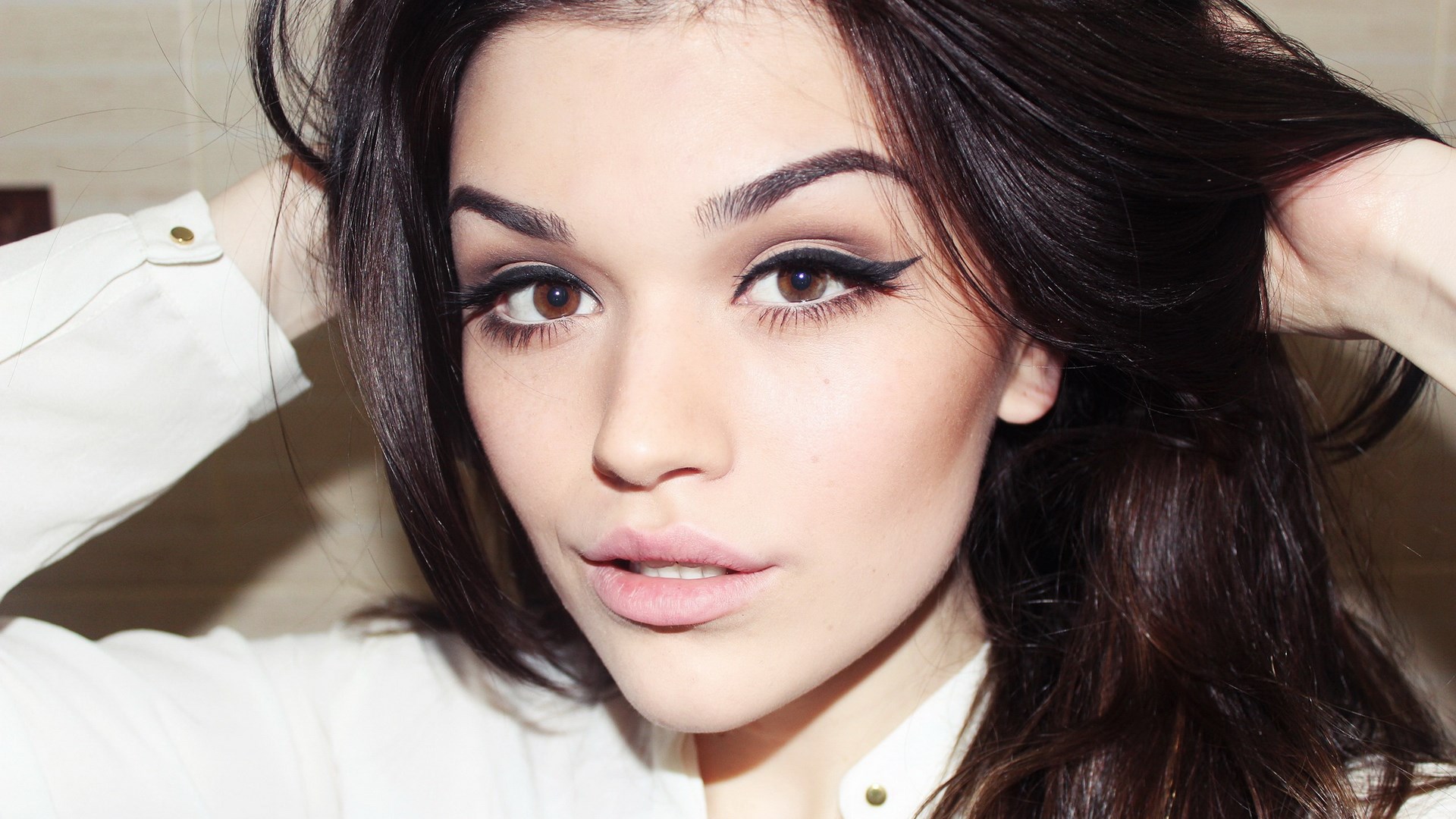 Woman with dark hair and makeup HD Wallpaper