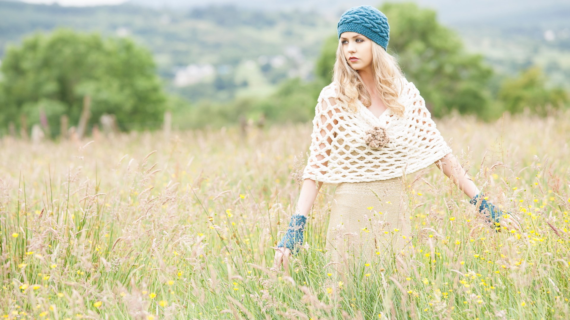 Woman in a field wearing a knitted hat and shawl HD Wallpaper