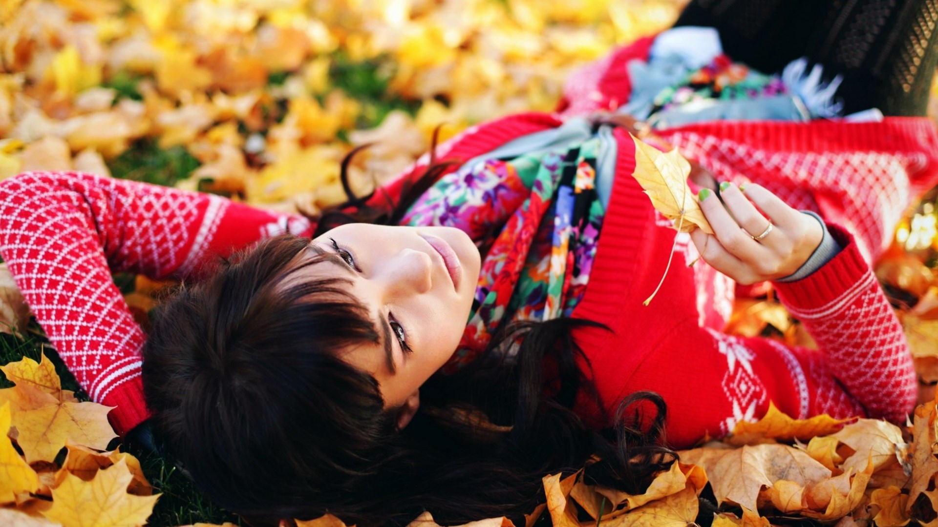 Woman lying in autumn leaves HD Wallpaper
