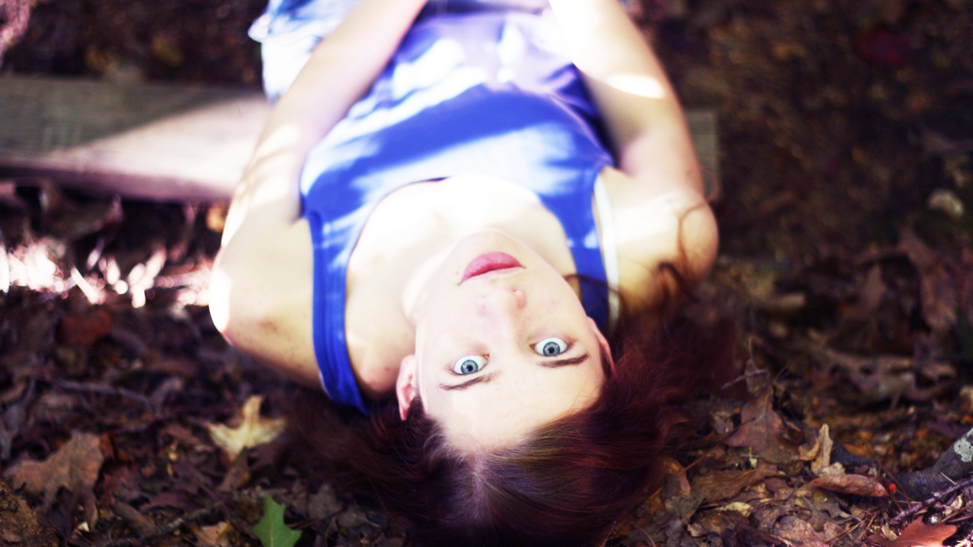 Woman lying on the ground with leaves HD Wallpaper