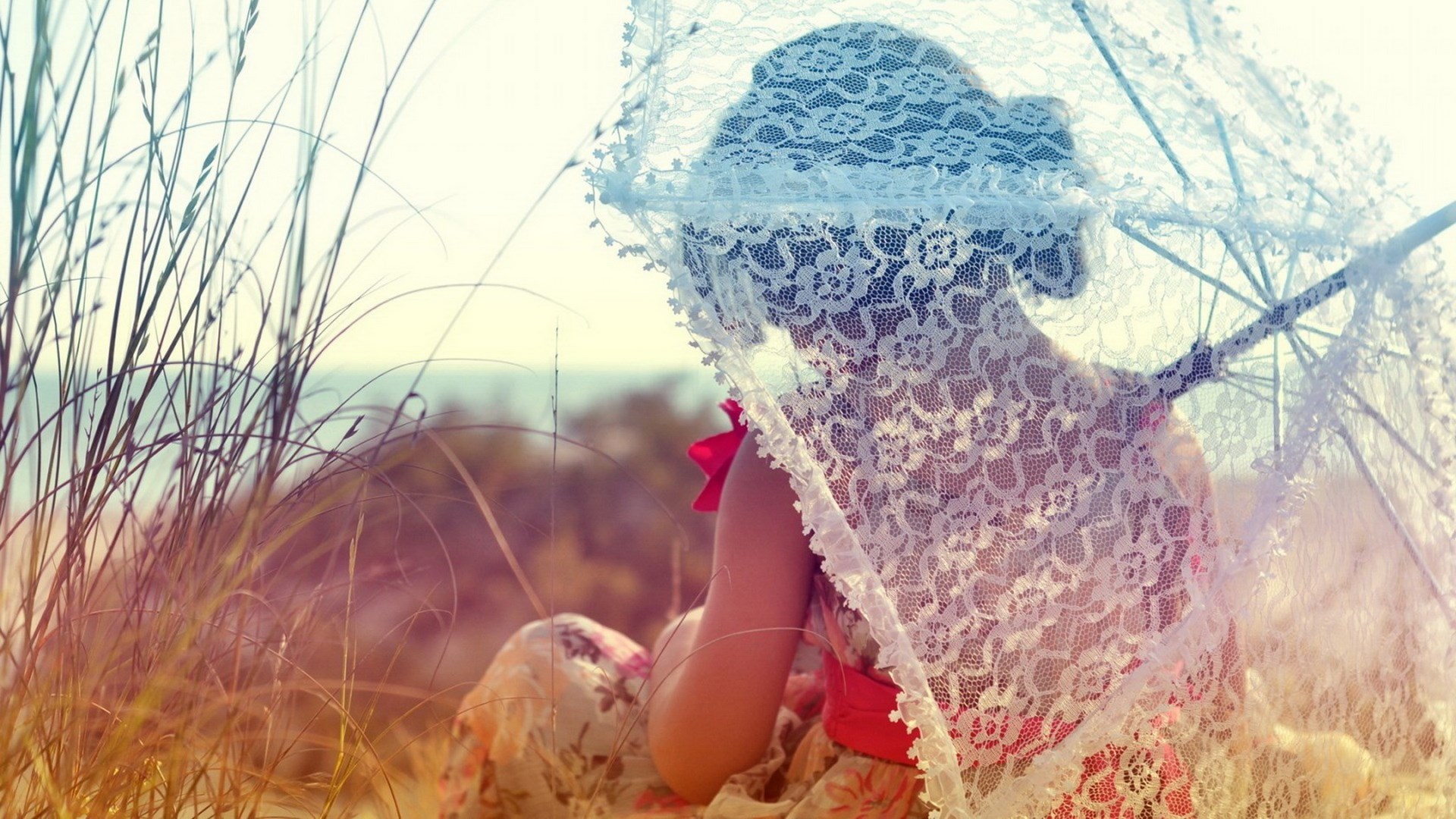 Girl with lace parasol in tall grass HD Wallpaper