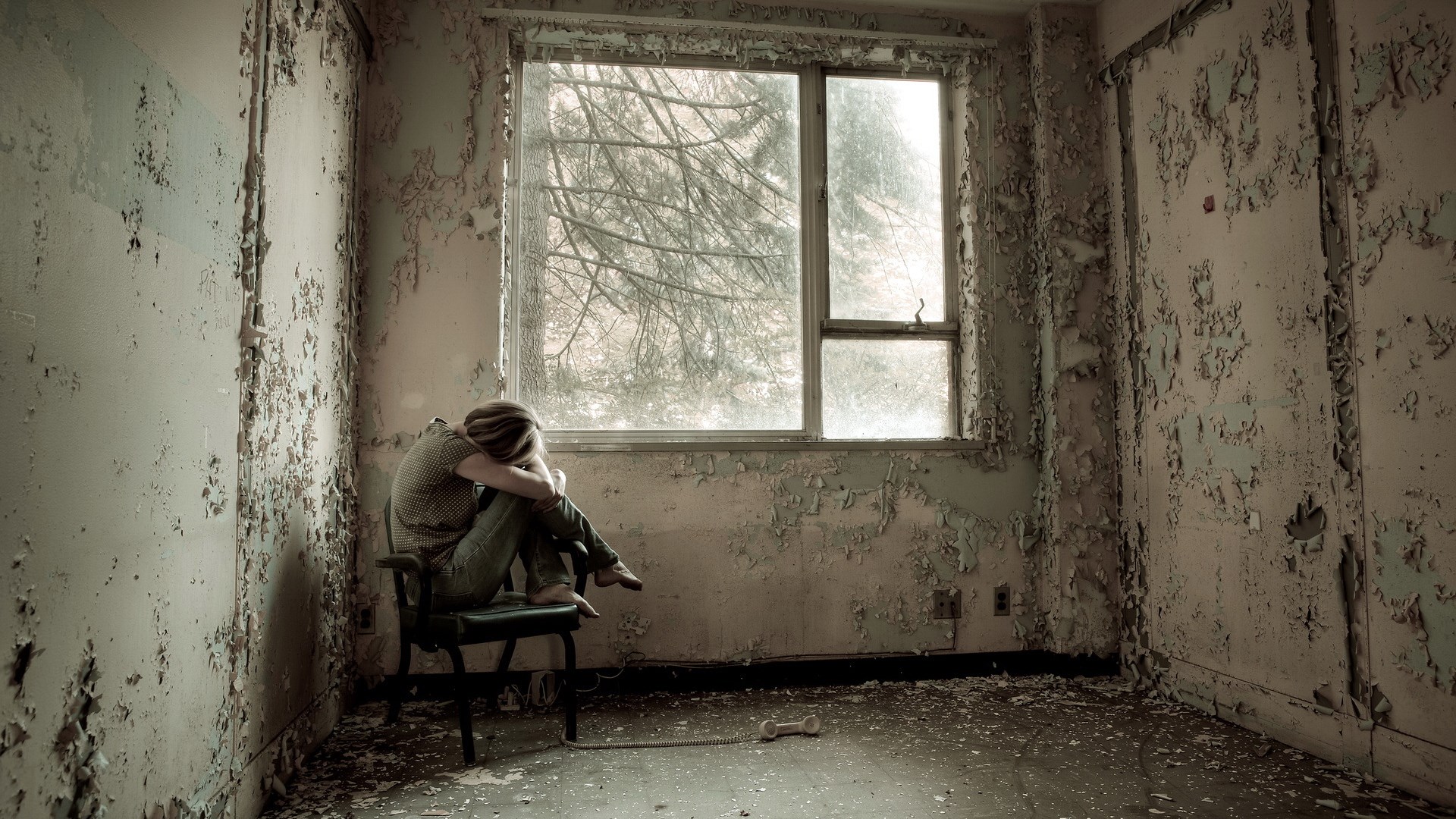 Person sitting in abandoned room by window HD Wallpaper