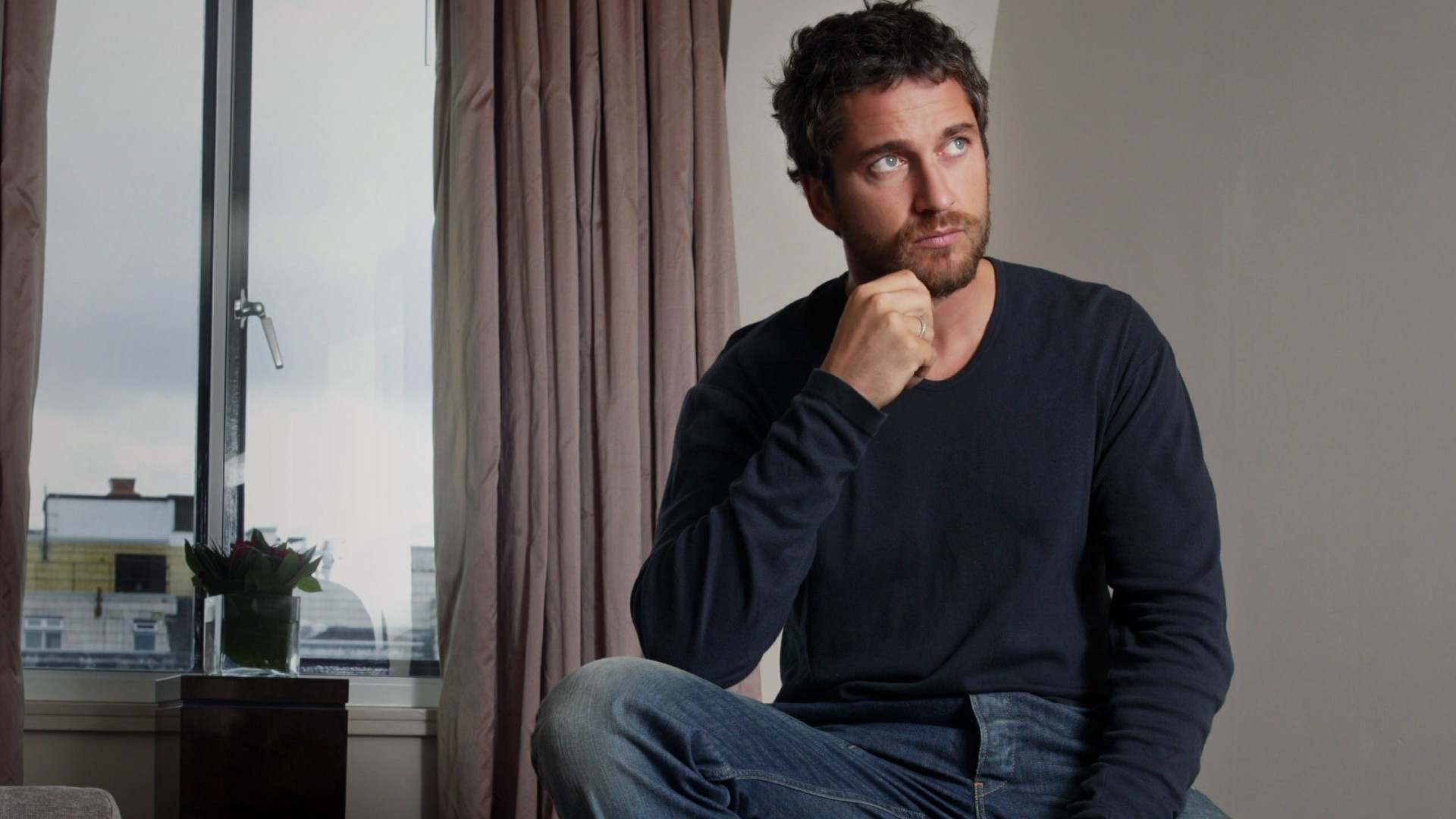 Gerard Butler sitting by the window HD Wallpaper