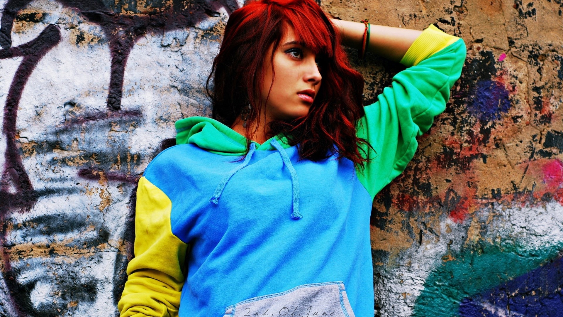 Girl with red hair leaning against graffiti wall HD Wallpaper