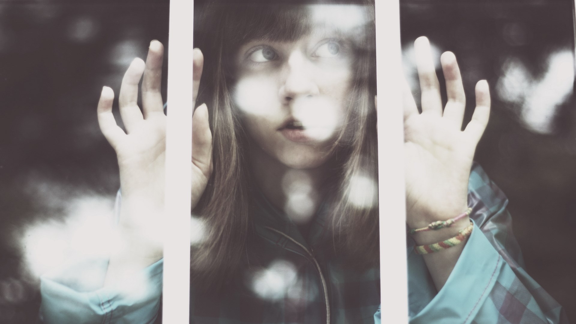 Girl looking through a window with hands pressed against it HD Wallpaper