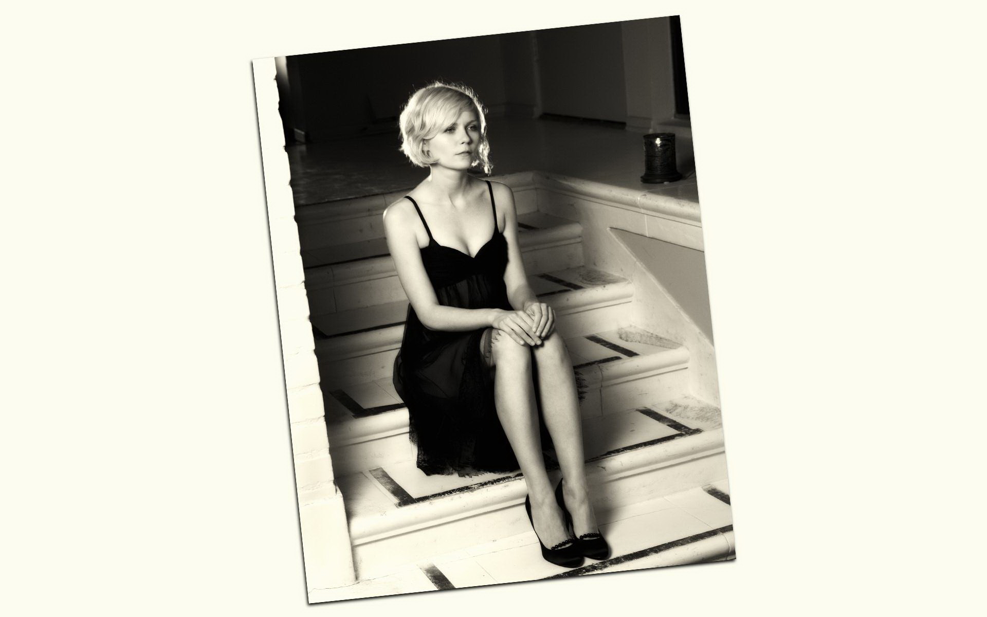 Kirsten Dunst in a black dress sitting on stairs HD Wallpaper