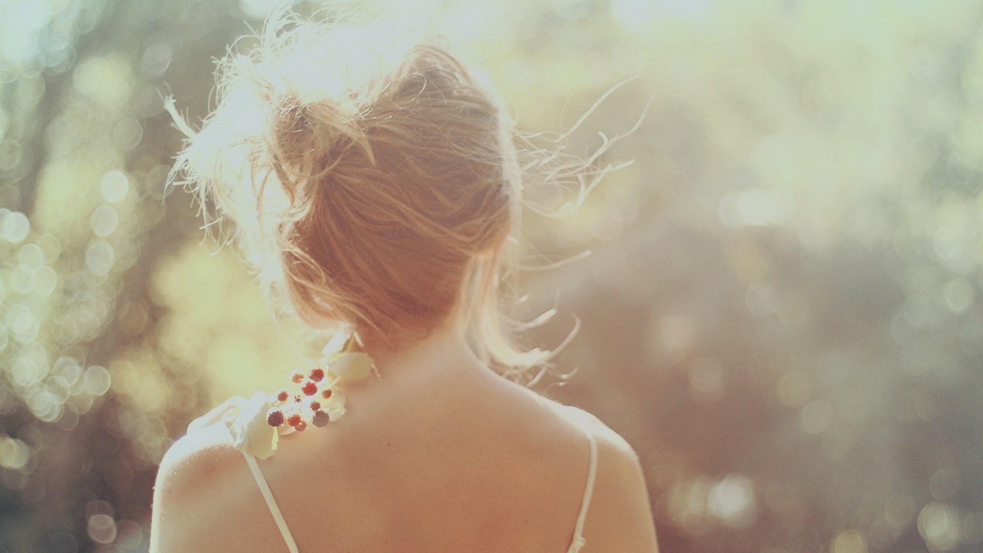 Woman with flowers on her shoulder in sunlight HD Wallpaper