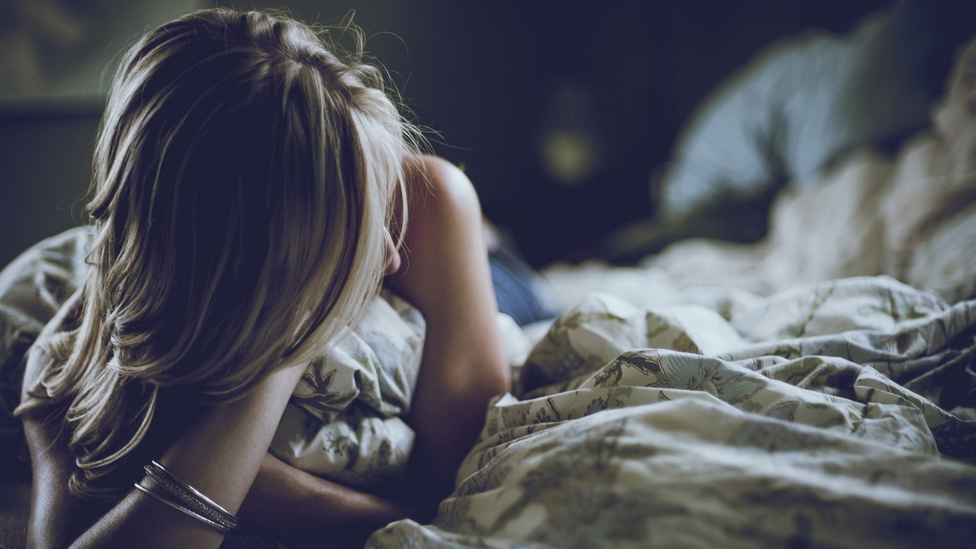 Woman lying in bed with blanket HD Wallpaper