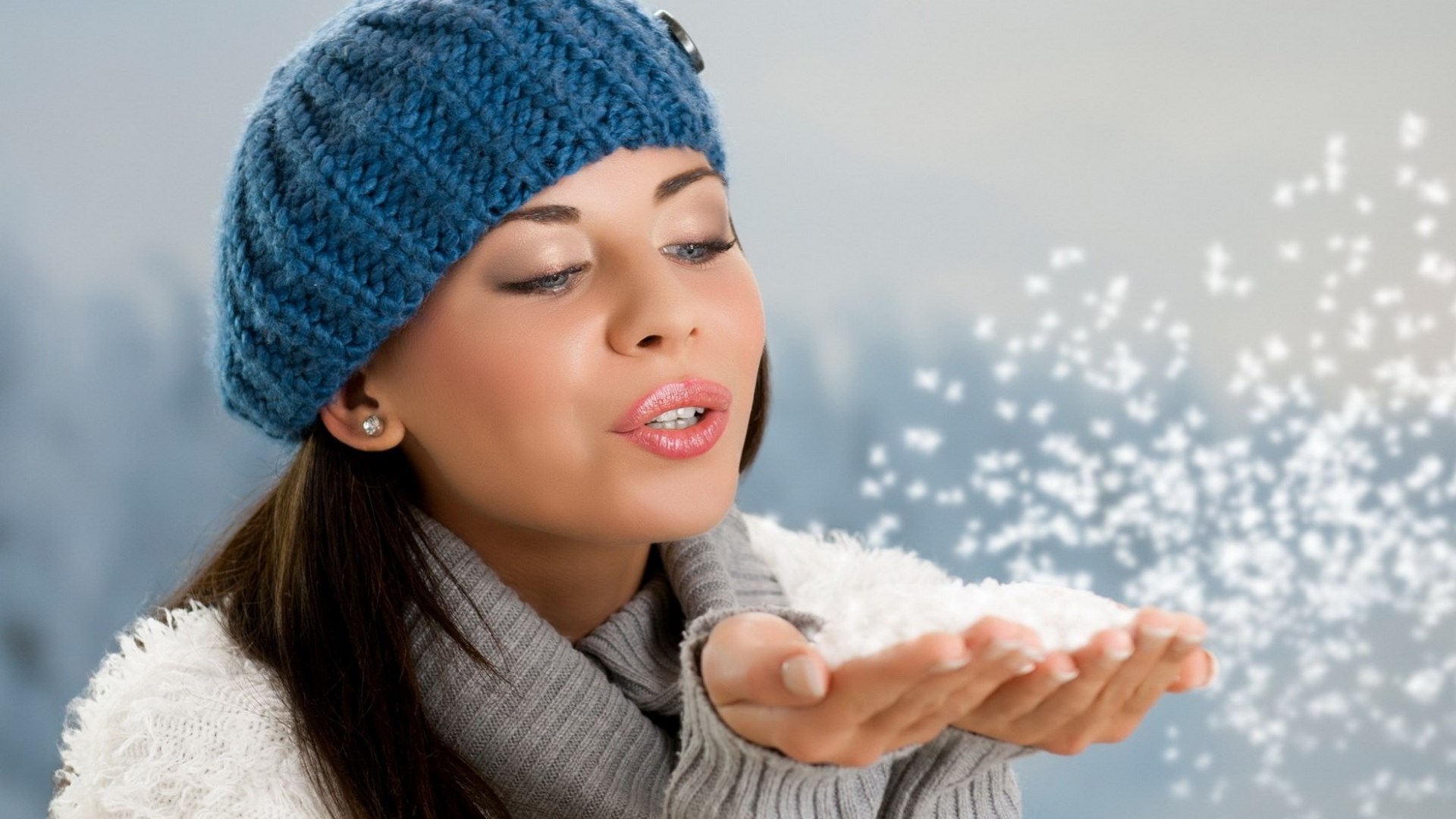Woman in blue hat blowing snow HD Wallpaper