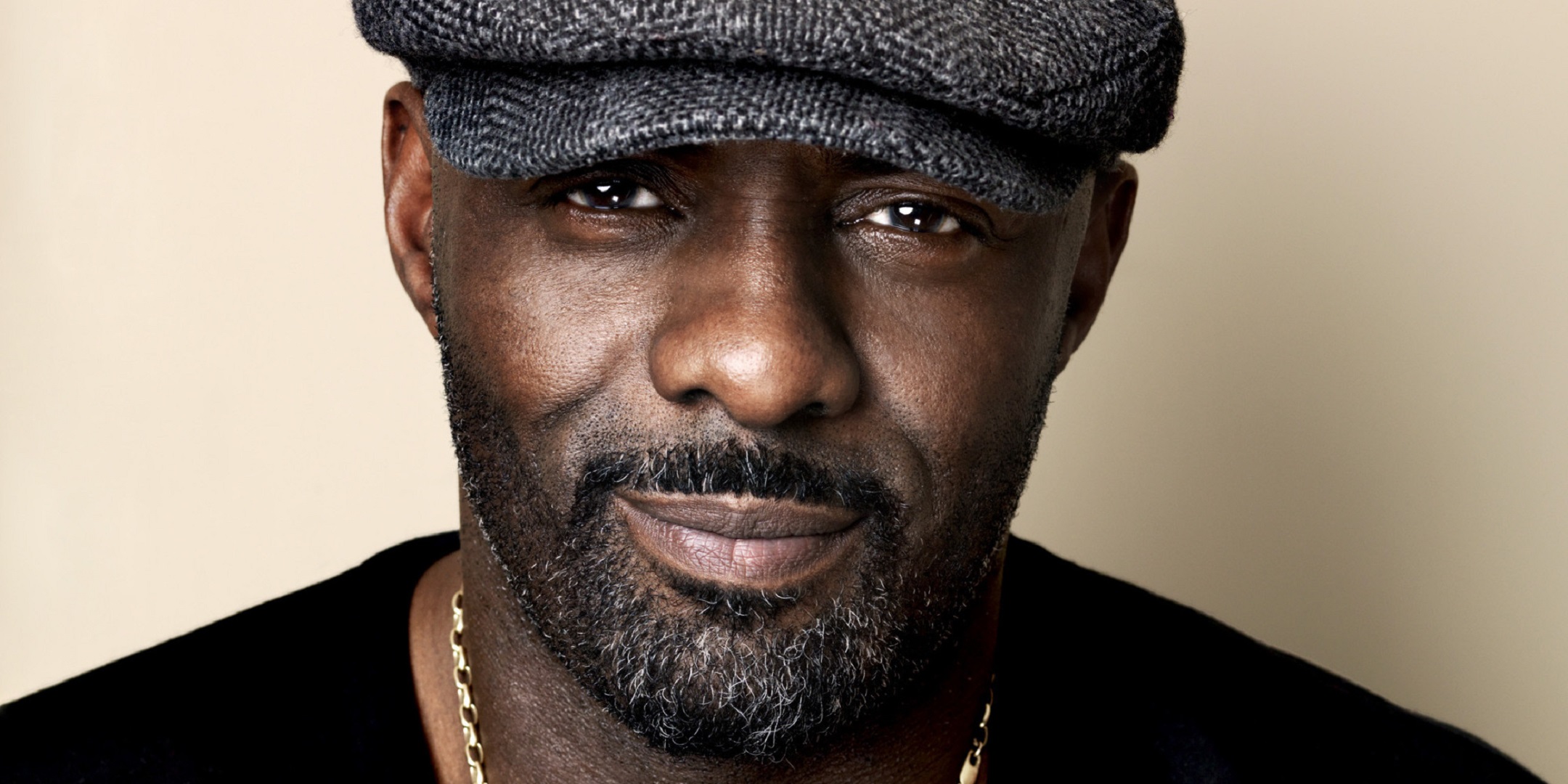 Idris Elba wearing a flat cap HD Wallpaper
