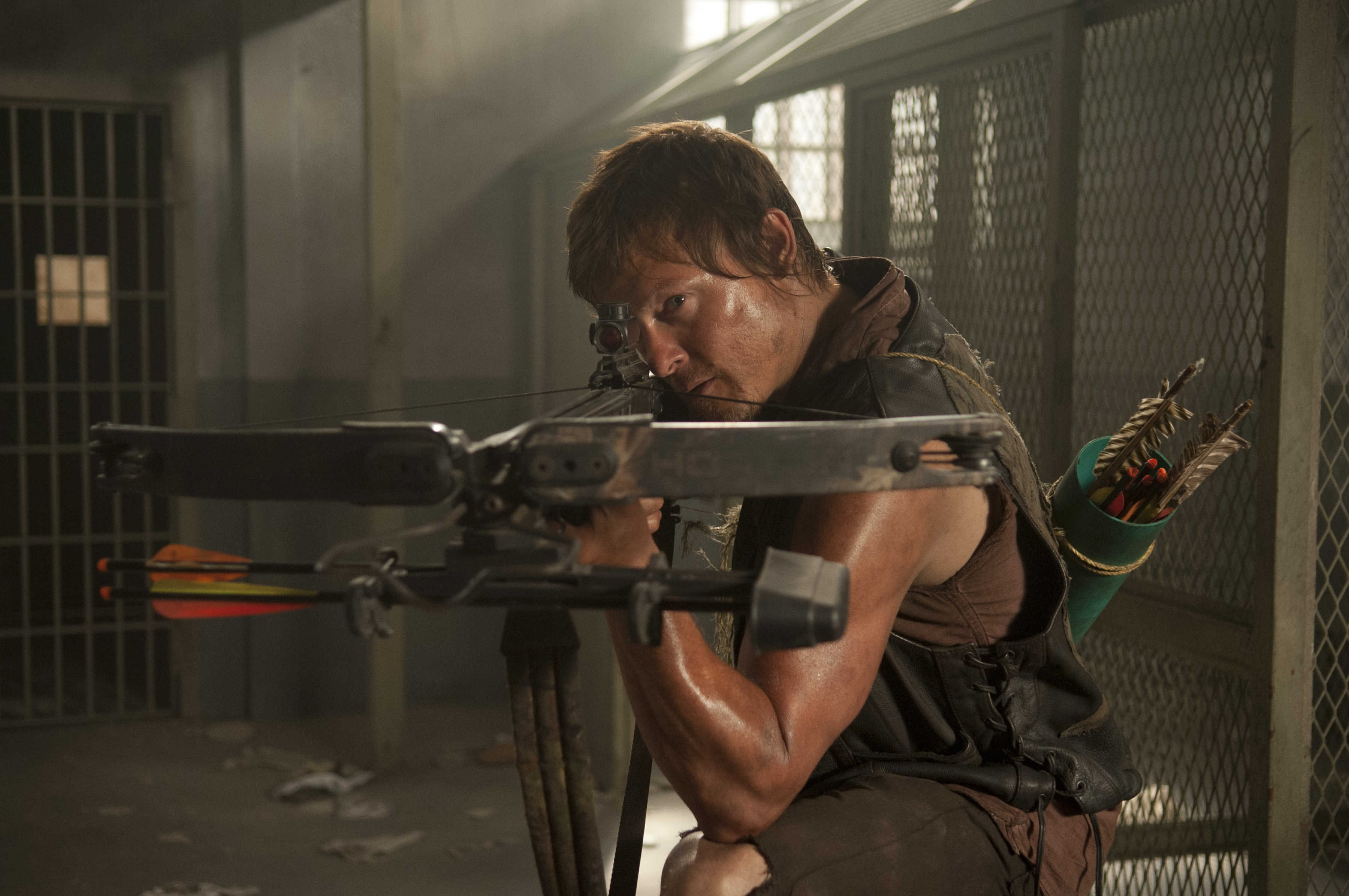 Norman Reedus with crossbow in prison HD Wallpaper