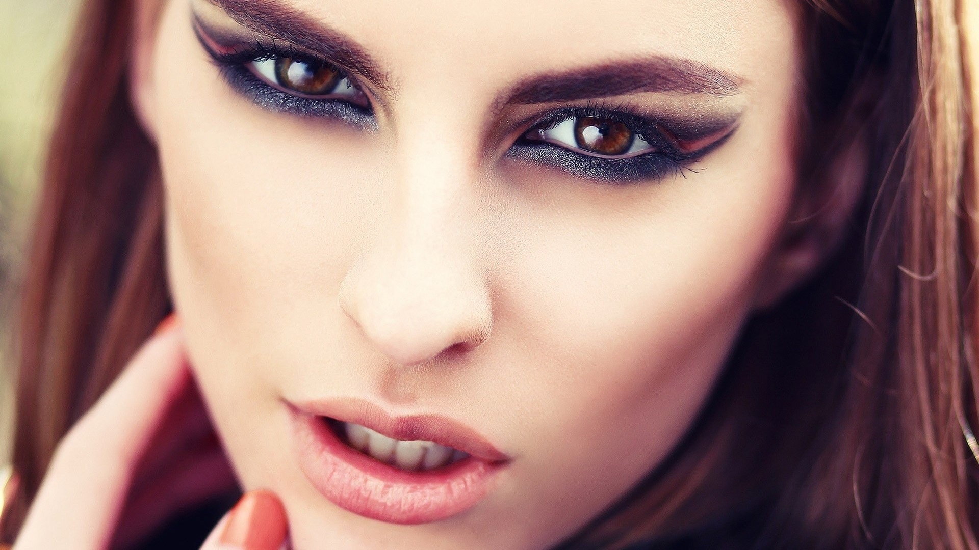Woman with dramatic eye makeup and red nails HD Wallpaper