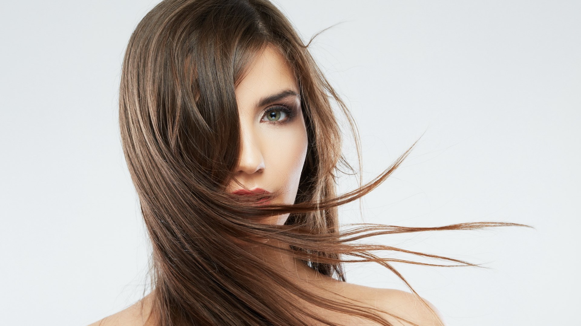 Woman with brown hair blowing in the wind HD Wallpaper