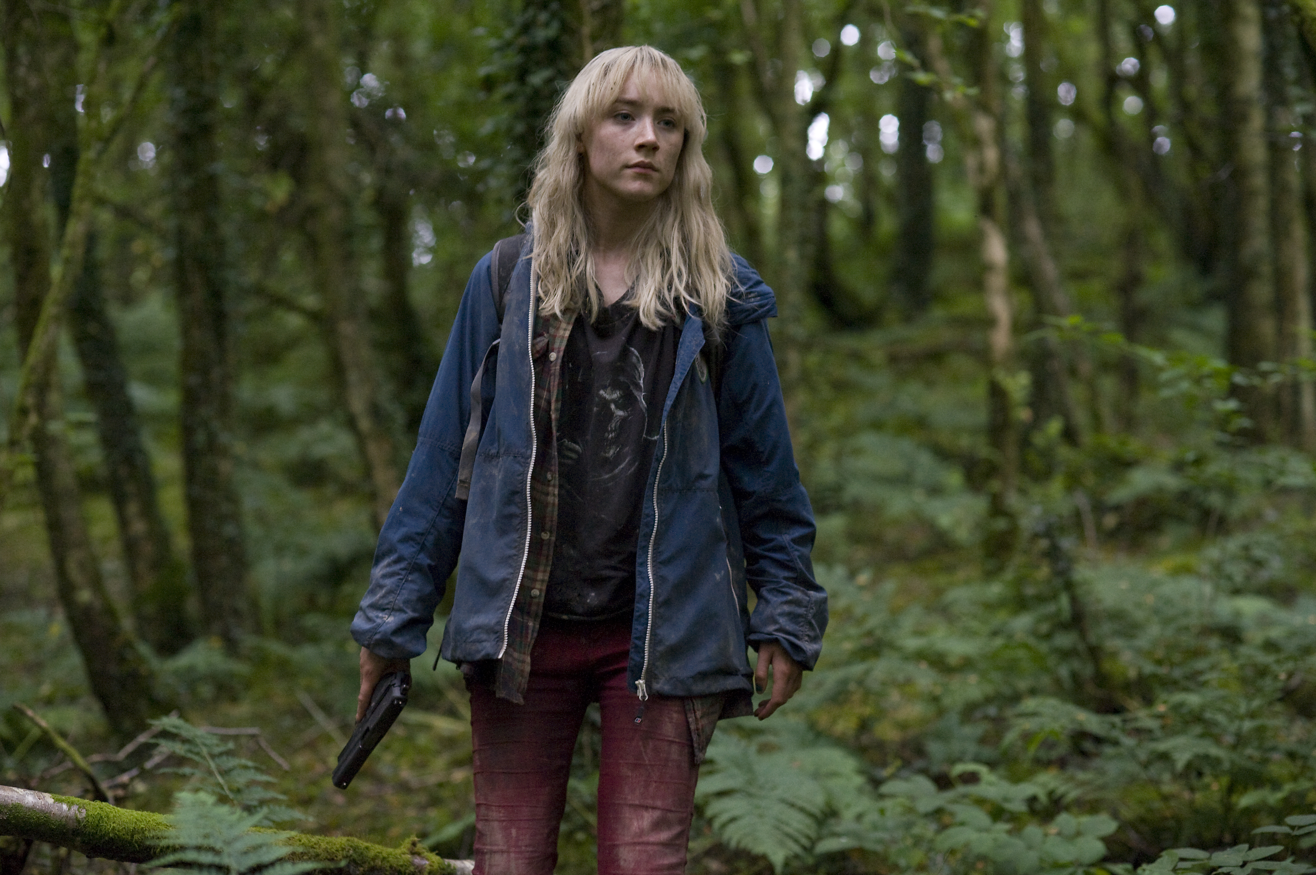 Saoirse Ronan in a forest holding a gun HD Wallpaper